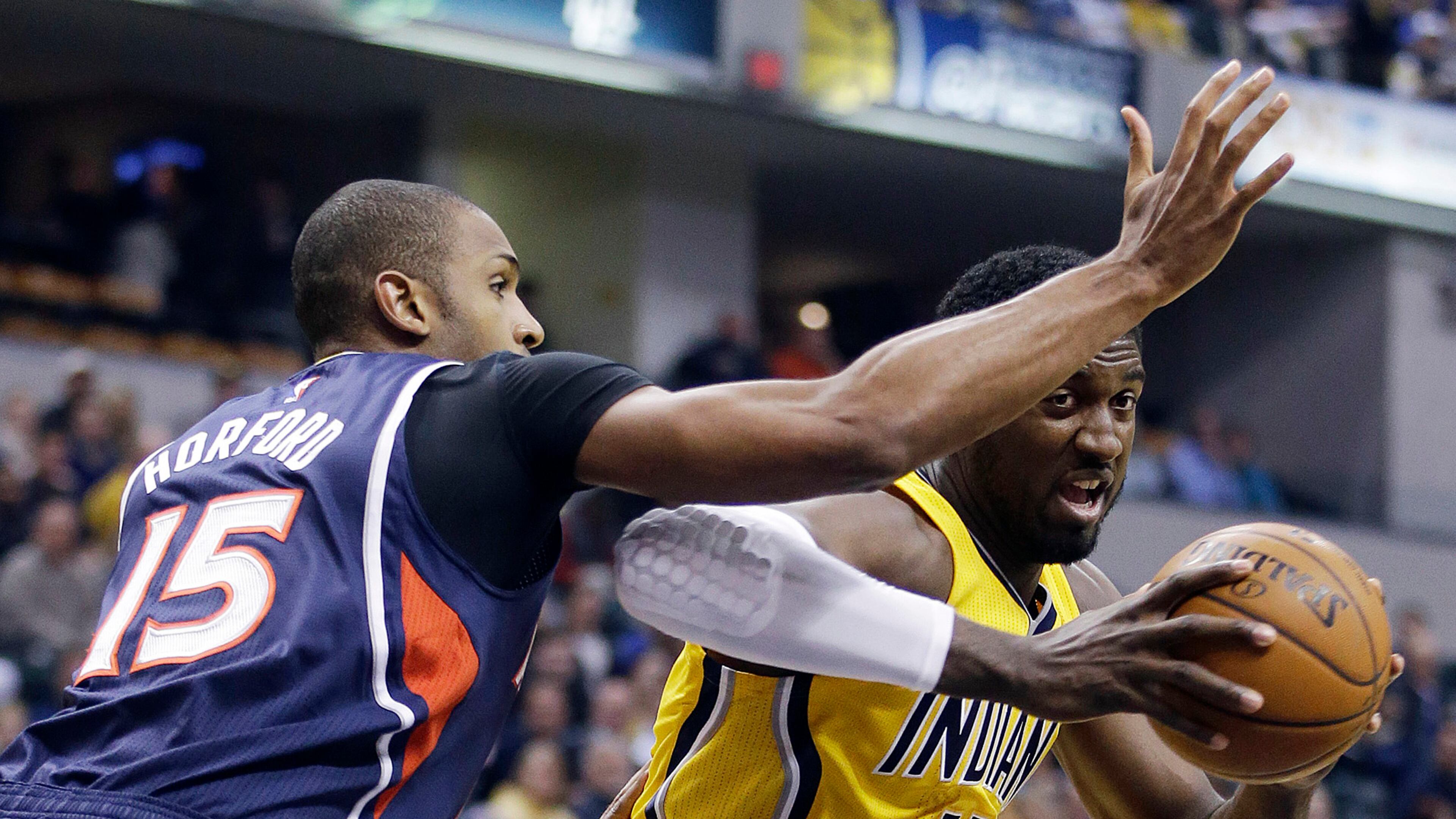 Indiana Pacers' Roy Hibbert (55) goes to the basket against Atlanta Hawks' Al Horford (15) during the first half of an NBA basketball game Monday, Dec. 8, 2014, in Indianapolis. (AP Photo/Darron Cummings)