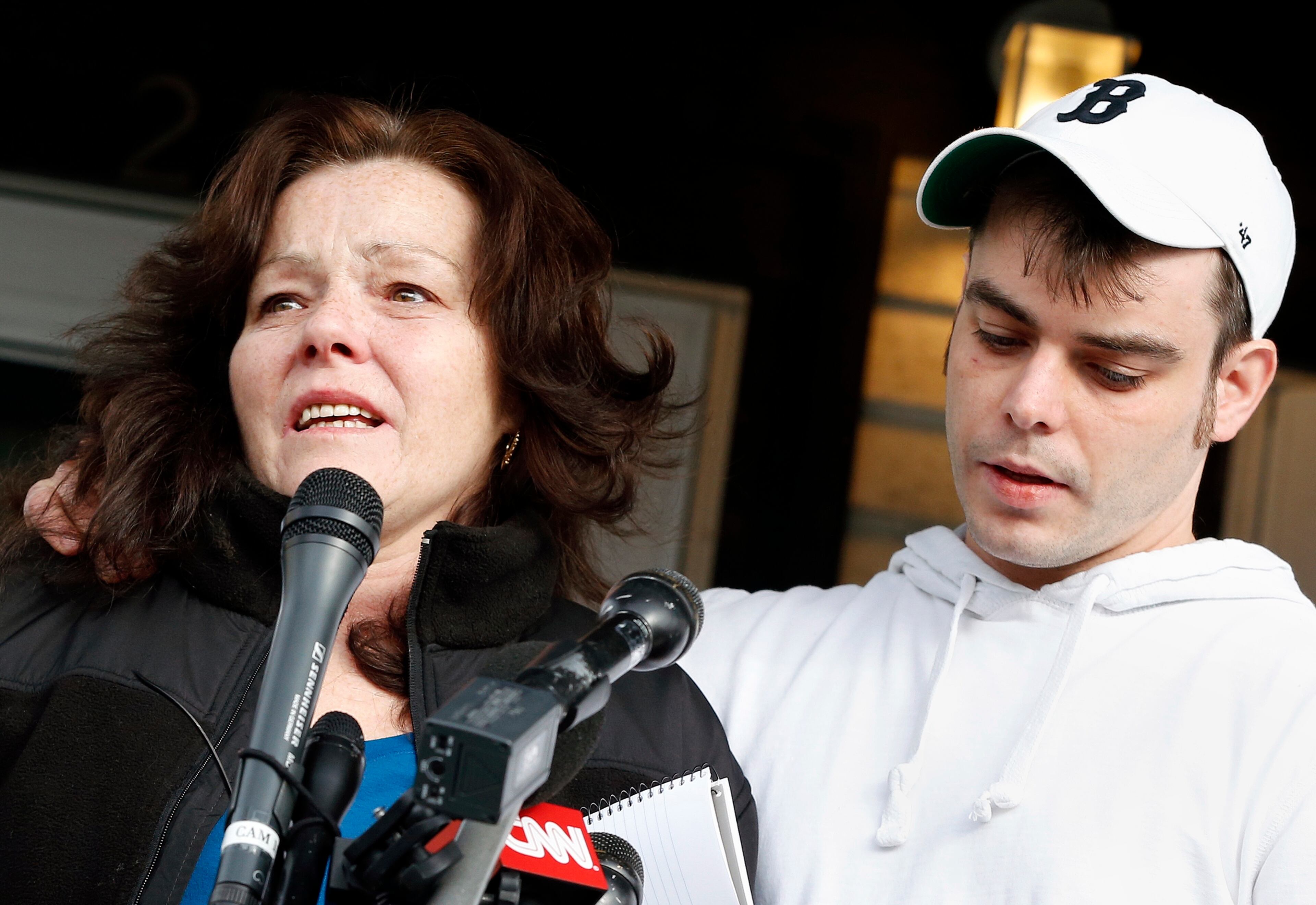 With her son, Billy, standing beside her, Patty Campbell, left, makes a statement to reporters outside her home in Medford, Mass.