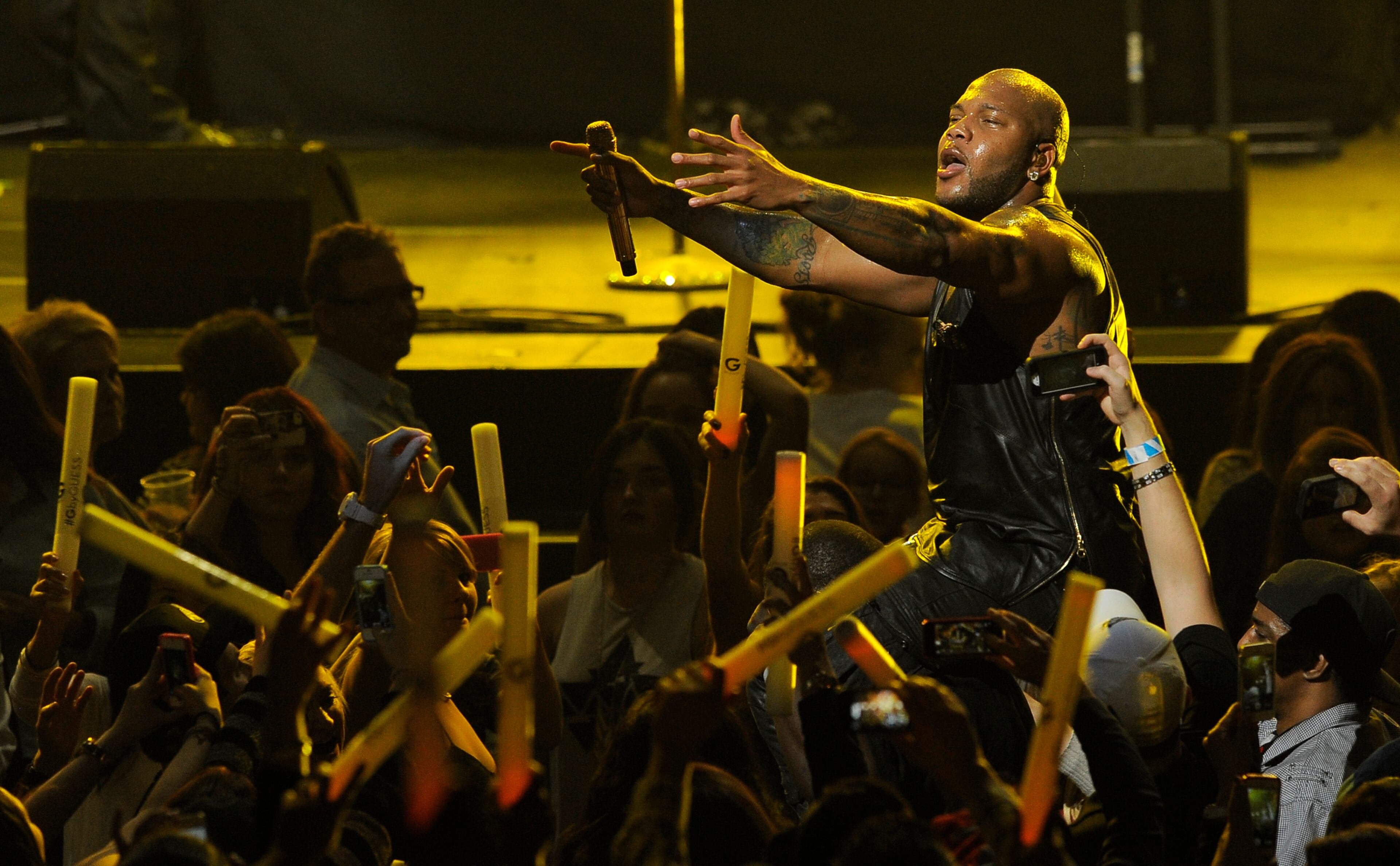 Flo Rida wades into the audience during his performance on the second night of KIIS FM's Jingle Ball. (Photo by Chris Pizzello/Invision/AP)