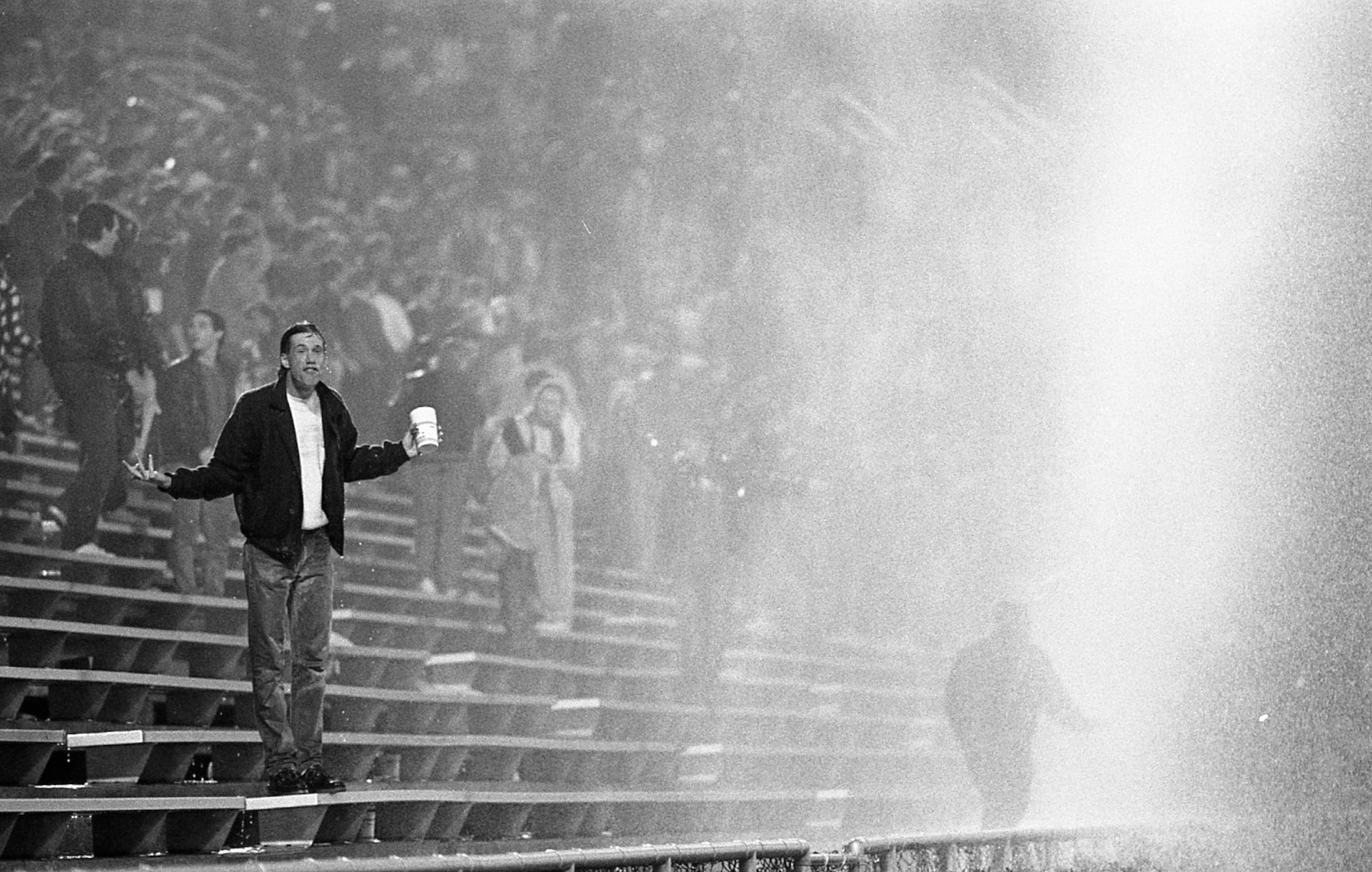 Fans in the stands get sprayed by the powerful water hoses. Photo by Louie Favorite / AJC