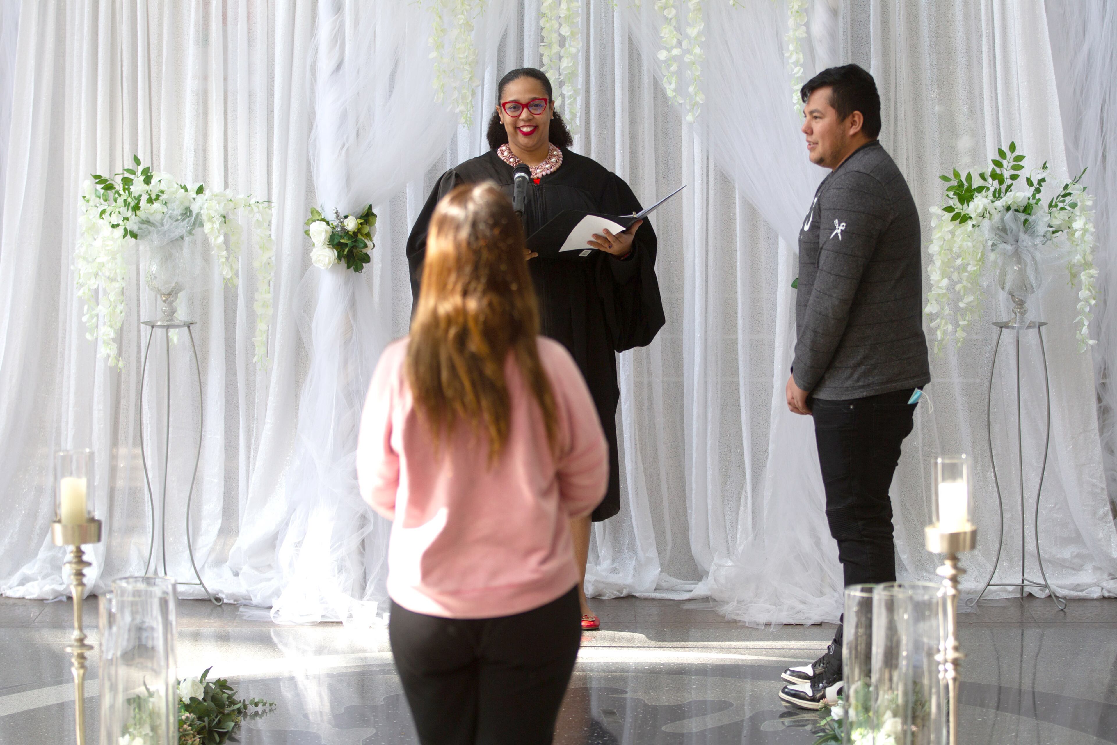 Judge Shermela J. Williams and Broderick Mathews watched Reagyn Buckler walk down the aisle during the wedding ceremony in the Atrium of the Fulton County Gov. Bldg. on valentines day, February 14, 2022. STEVE SCHAEFER FOR THE ATLANTA JOURNAL-CONSTITUTION