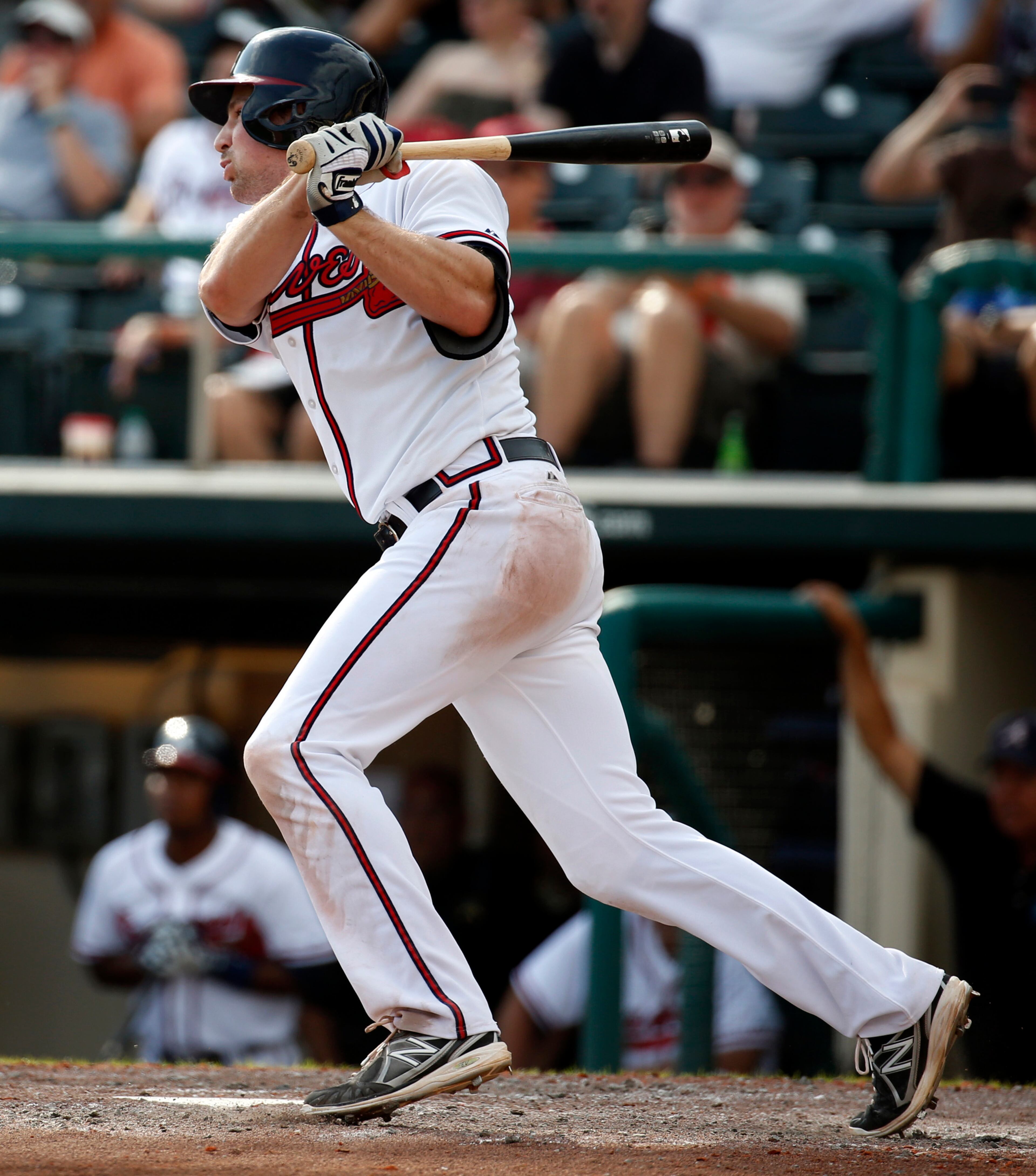 Atlanta Braves' Phil Gosselin follows through on a three-run triple in the eighth inning of anexhibition baseball game against the Washington Nationals, Tuesday, March 4, 2014, in Kissimmee, Fla. The Braves won 8-4.