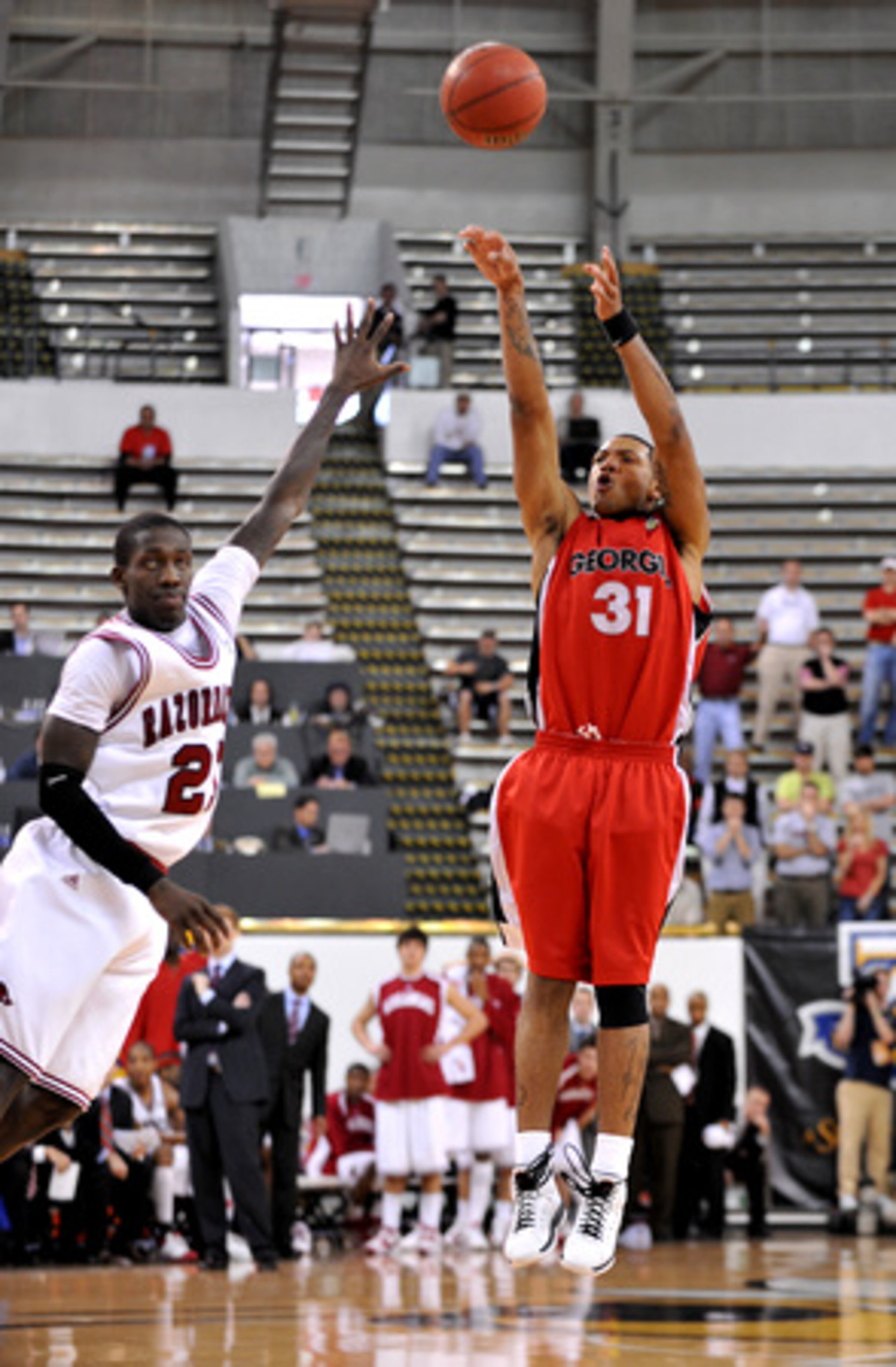 Georgia's Billy Humphrey nails a three-pointer over Patrick Beverley of Arkansas with 1:27 to play in the game.