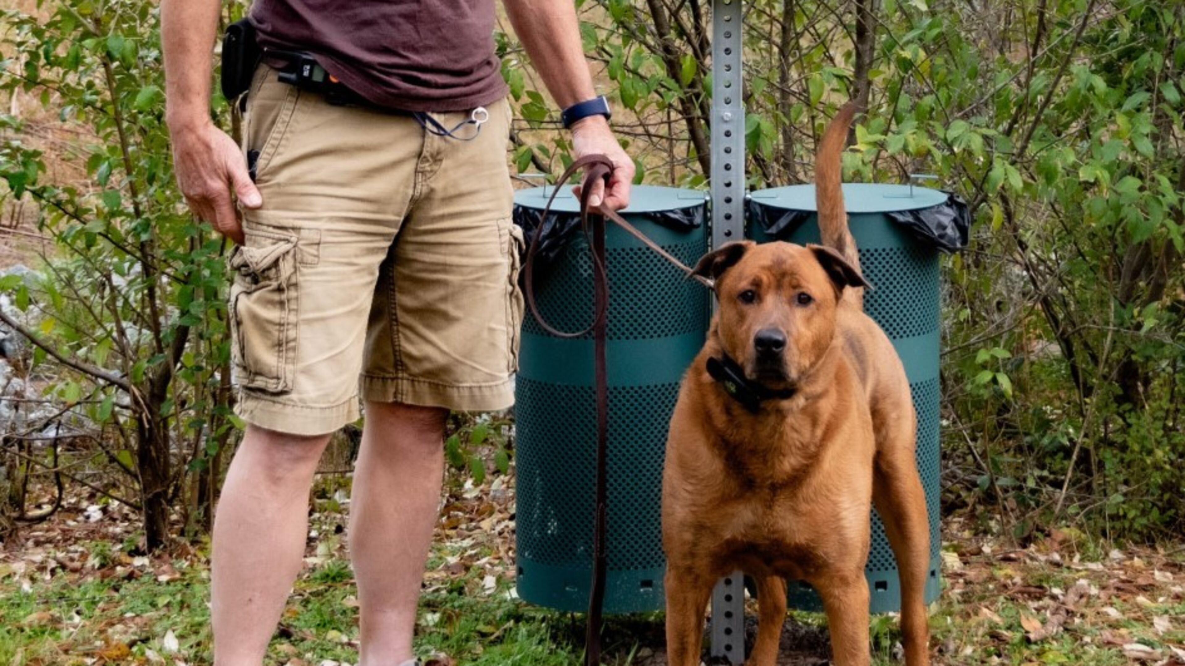 Chris Gleason and his dog Gus stop by the new dog waste bin at the Jones Bridge unit of the Chattahoochee River National Recreation Area (CRNRA). 37 new dog waste bins funded by the Chattahoochee National Park Conservancy and the National Park Service were installed throughout the CRNRA. photo by Evan Barnard.