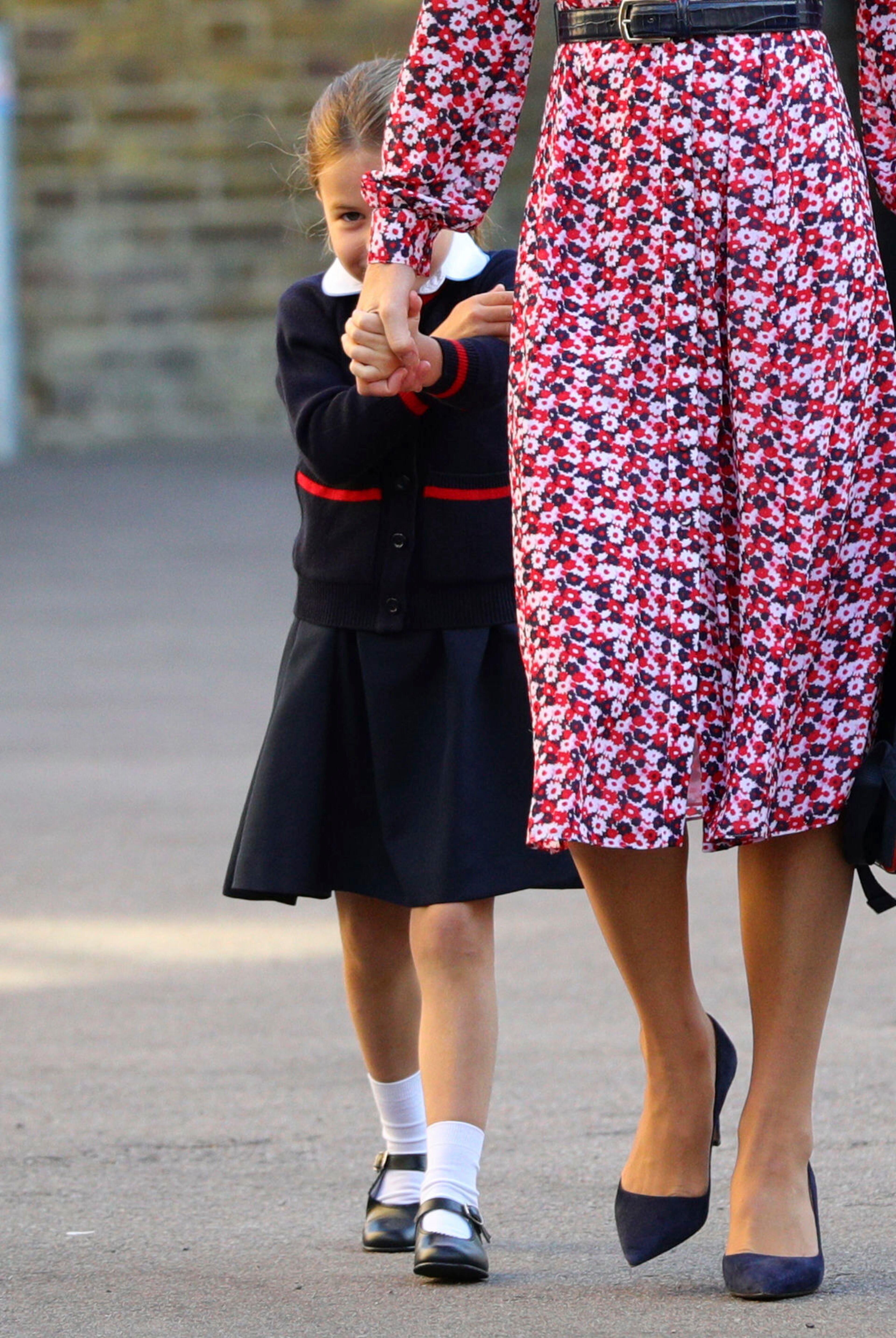 Britain's Princess Charlotte, left, arrives for her first day of school at Thomas's Battersea in London, with her mother Kate, Duchess of Cambridge, her father Prince William and her brother Prince George Thursday Sept. 5, 2019. (Aaron Chown/Pool via AP)