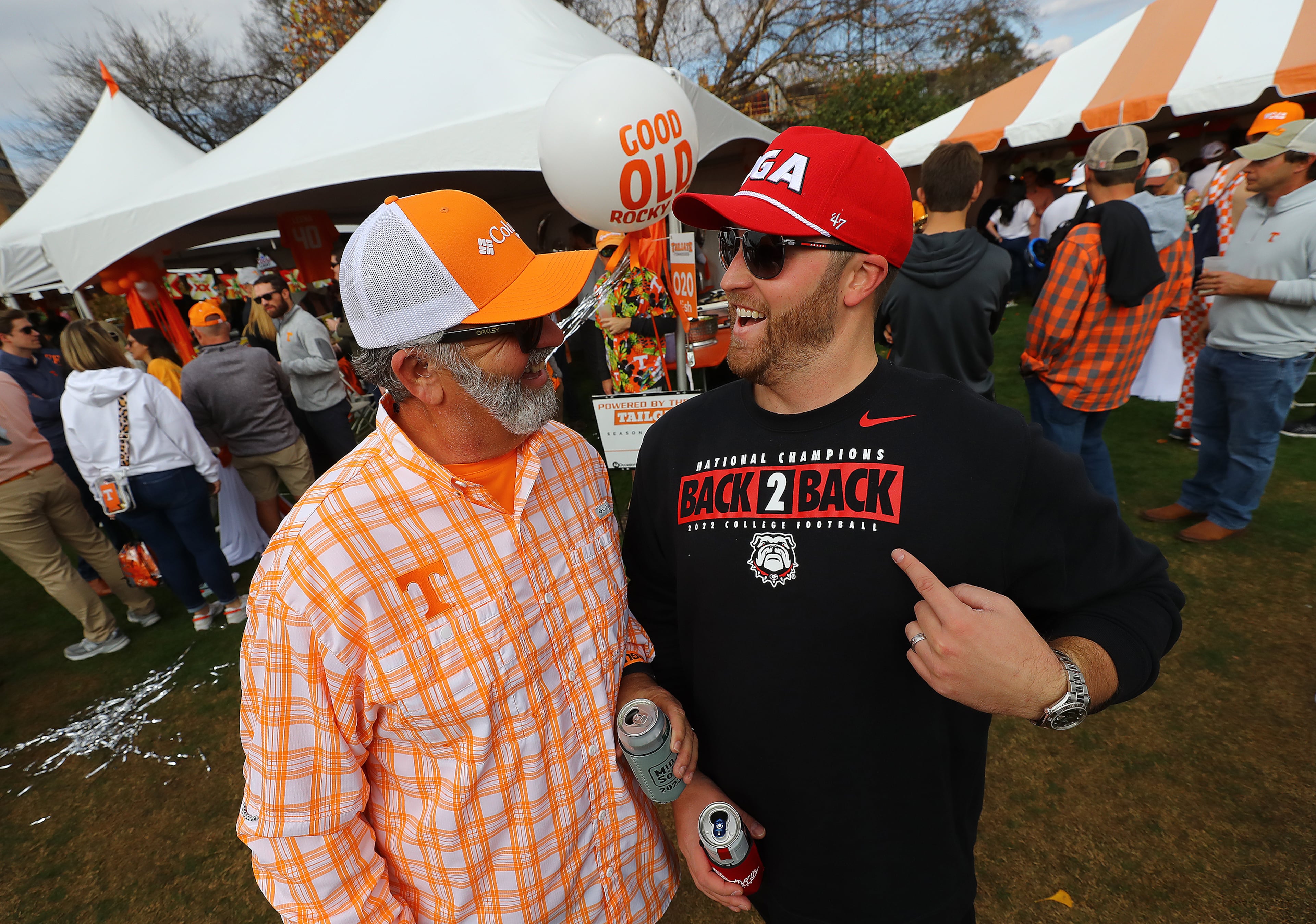 Georgia fan Jake Mathis, Alpharetta, sports his Back-2-Back National Champions shirt while greeting his Tennessee fan friend Chris Tallent, Dalton, arriving for the NCAA college football game on Saturday, Nov. 18, 2023, in Knoxville. Curtis Compton for the Atlanta Journal Constitution