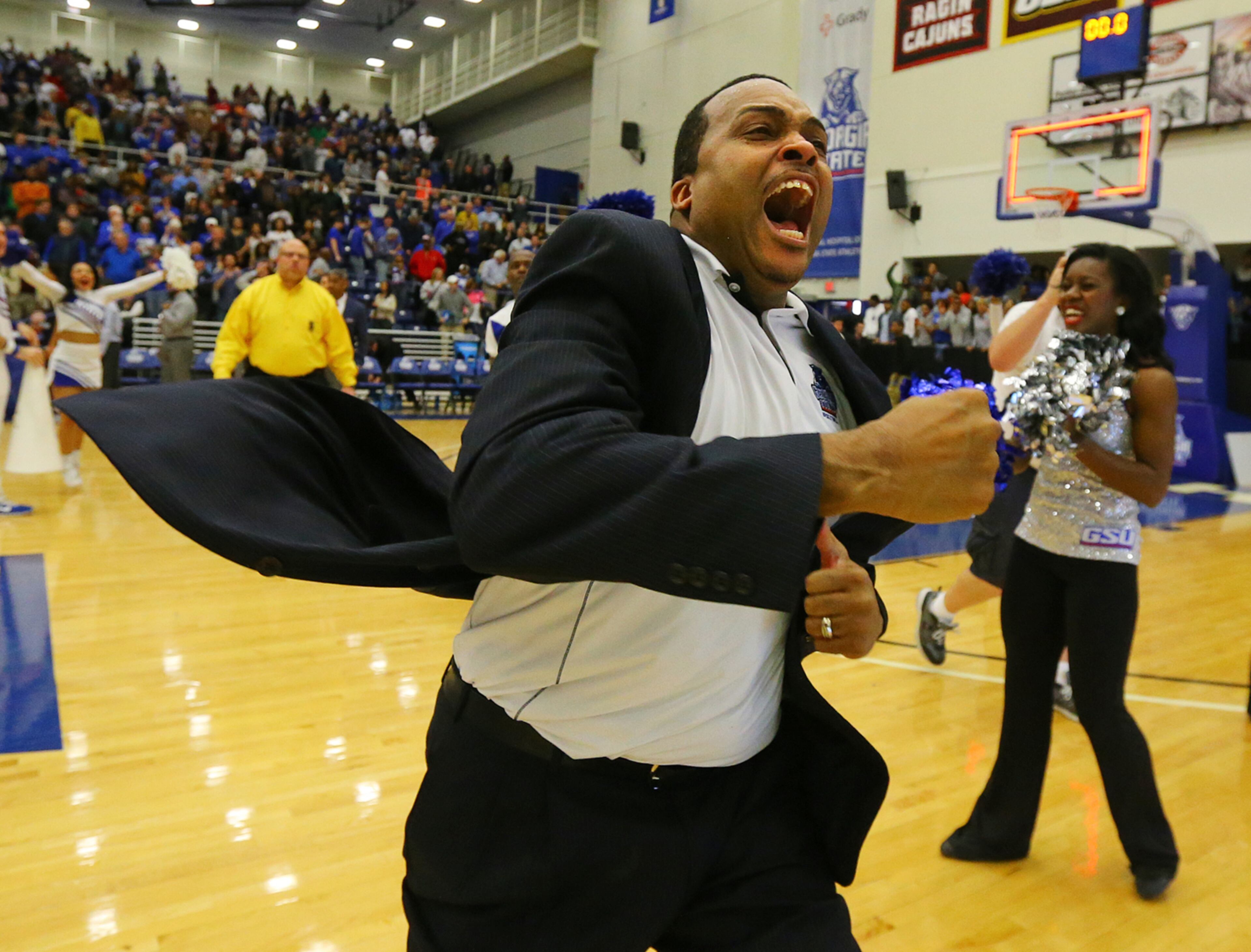 WINNING THE BELT--030715 ATLANTA: Georgia State head coach Ron Hunter reacts to winning the Sunbelt Men's Basketball Regular Season Championship charging the fans after beating Georgia Southern 72-55 in a basketball game on Saturday, March 7, 2015, in Atlanta. Curtis Compton / ccompton@ajc.com