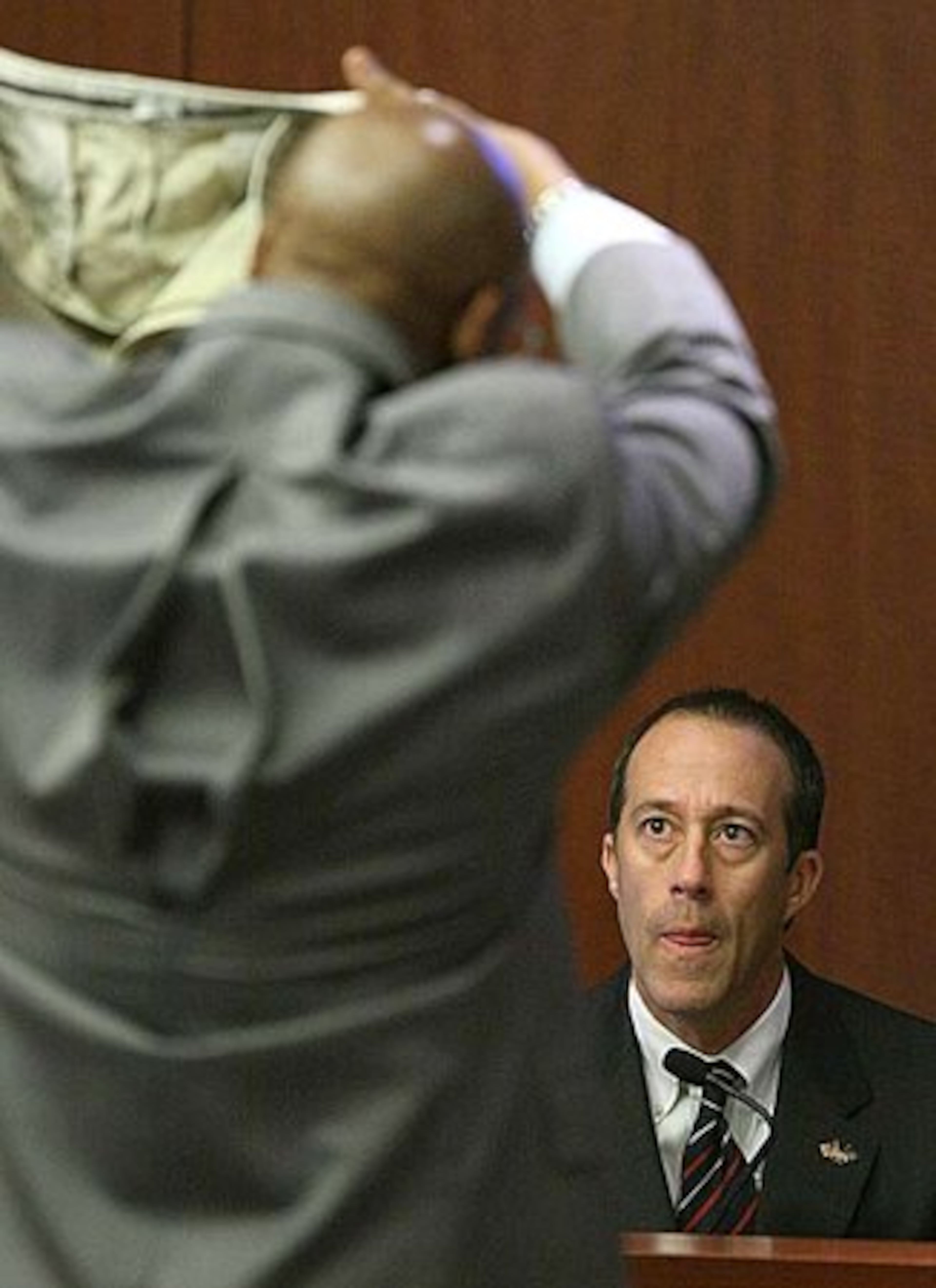 Prosecutor Clint Rucker shows to FBI Special Agent Joseph Fonseca the pants Brian Nichols wore on the day of his surrender.