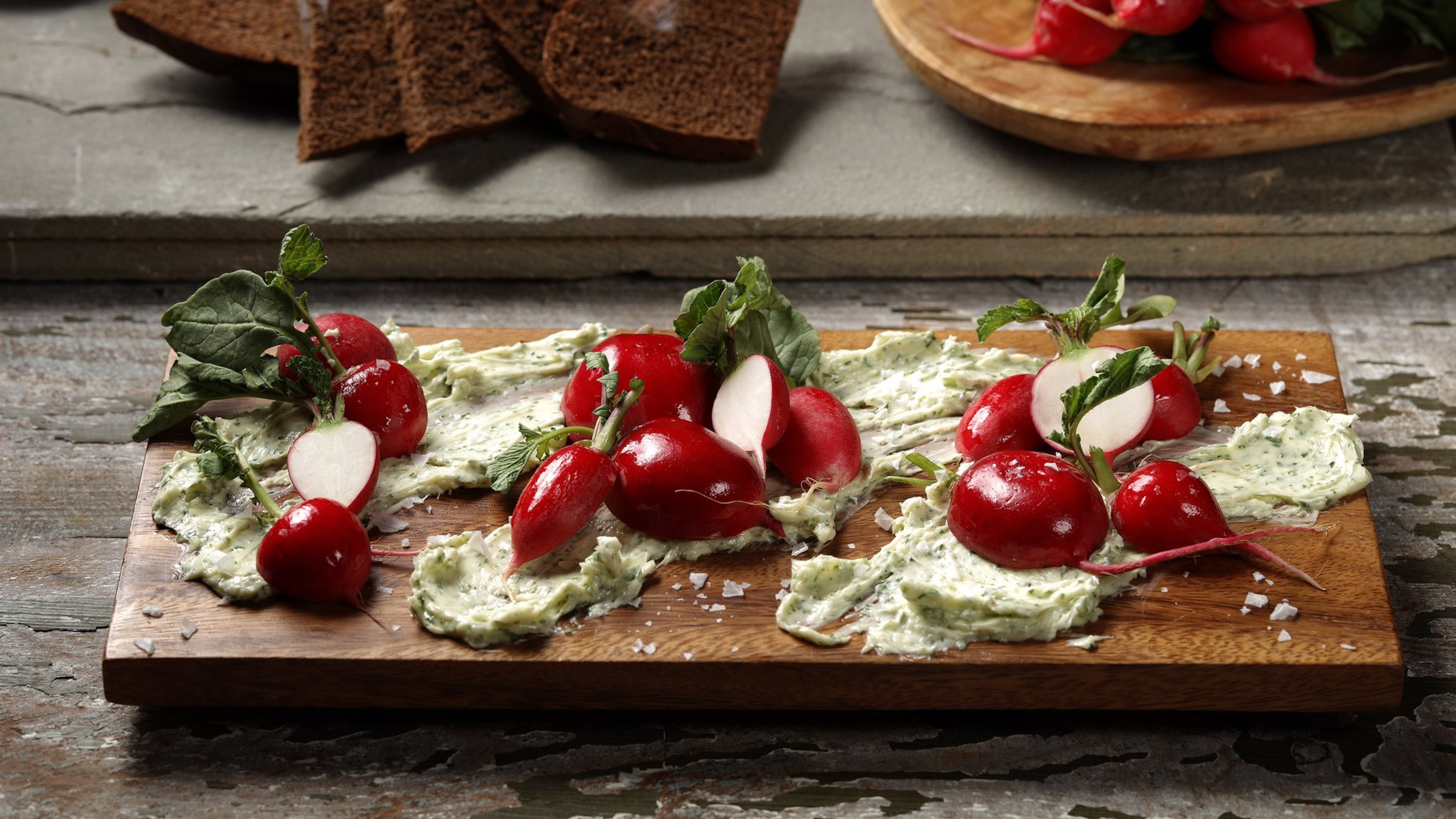 Mix fresh chopped dill and parsley into good butter, give it a squeeze of lemon and a bit of garlic, and use it as a rich bed for sharp-tasting radishes. (Abel Uribe/Chicago Tribune/TNS)