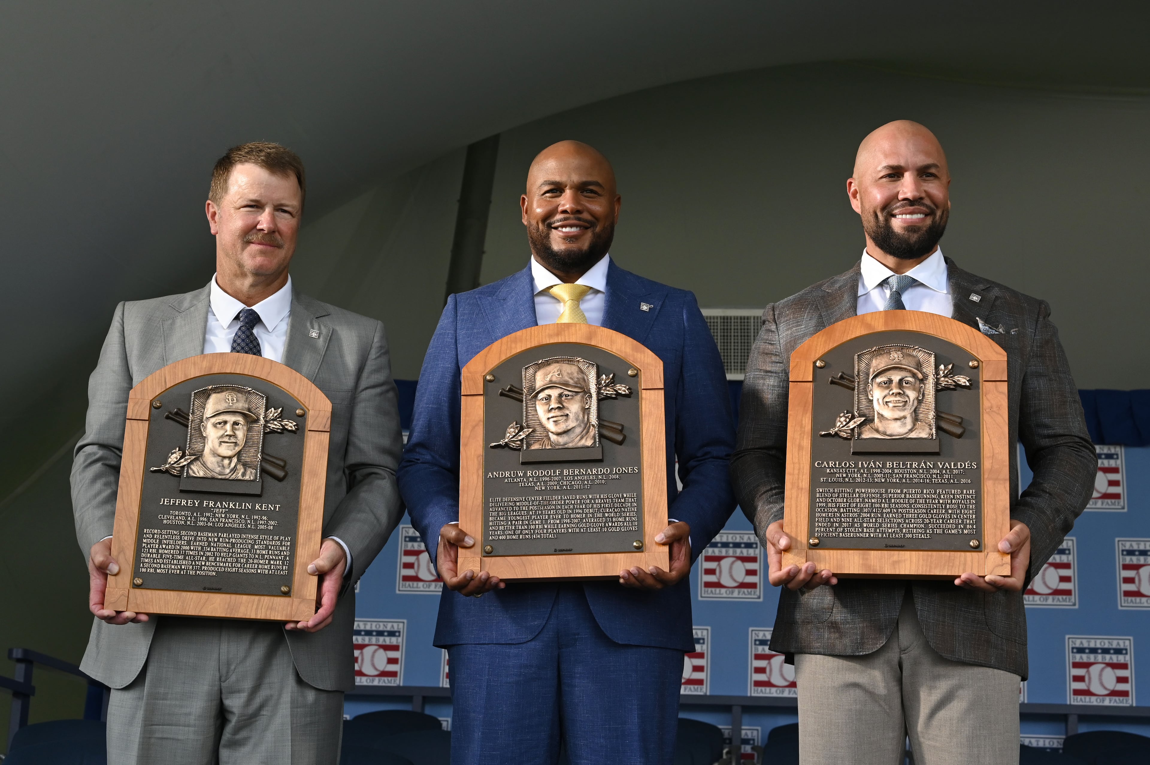The Class of 2026 inductees, from left, Jeff Kent, Andruw Jones and Carlos Beltrán, pose with their Hall of Fame plaques during the 2026 National Baseball Hall of Fame Induction Ceremony at the Clark Sports Center on Sunday, July 26, 2026, in Cooperstown, N.Y. Braves centerfielder Andruw Jones is set for induction into the National Baseball Hall of Fame as part of the Class of 2026, alongside Carlos Beltrán and (Hyosub Shin/AJC)