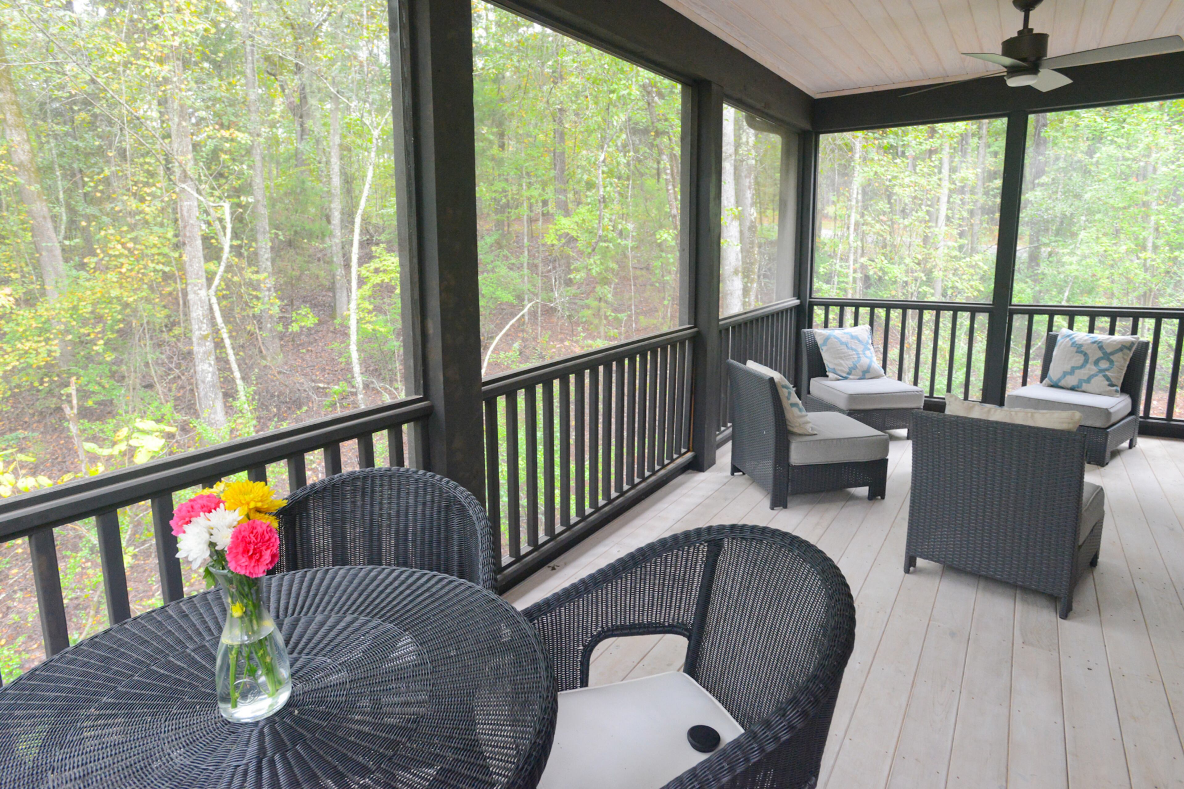 John and Lauren Kane's spacious screened-in porch provides plenty of room for entertaining and looks out onto the family's wooded lot in the Serenbe community in Chattahoochee Hills.