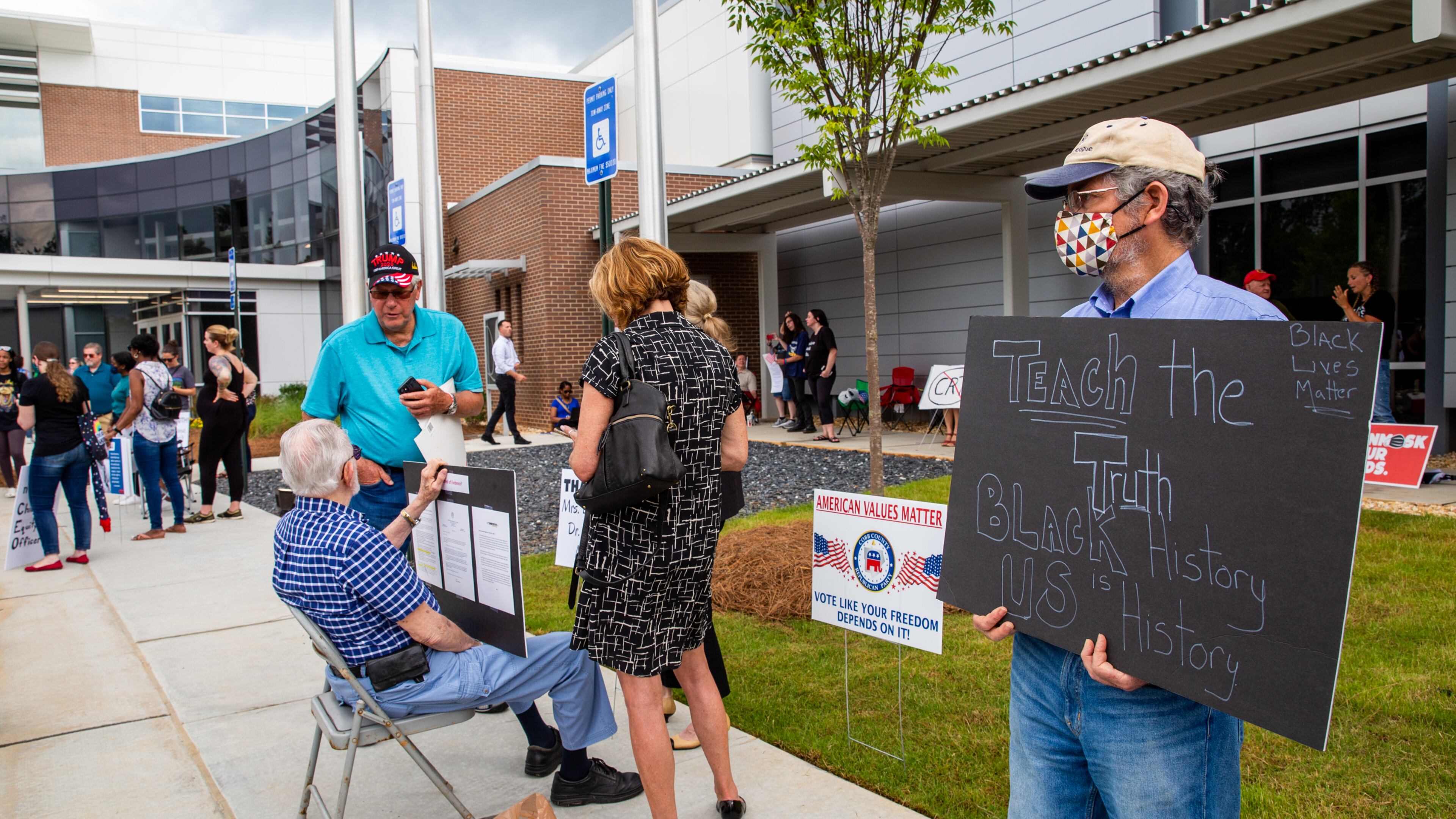 Before a Cobb County School Board meeting begins, Gregory Farino expresses his perspective as teachers, parents and local residents gather to voice their opinions on critical race theory and what Cobb County teaches and the reviews initiated by the school board Thursday, June 10, 2021. (Jenni Girtman for The Atlanta Journal Constitution)