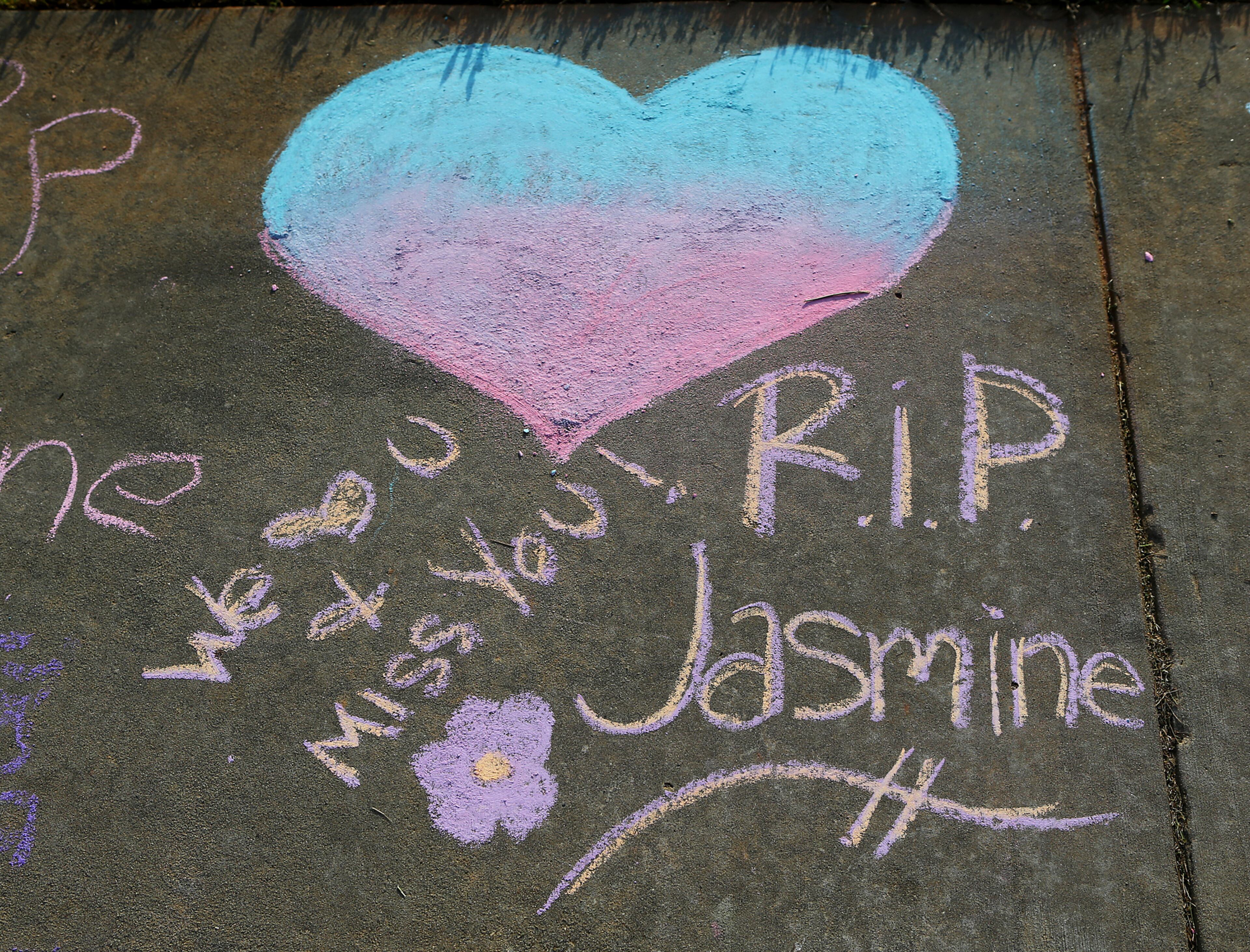 Before the vigil, messages were written in chalk for Jasmine Poole, 16 on the sidewalk at Dutchtown High School on Thursday, May 8, 2014, in Hampton. Poole was killed and two other teens injured in a Wednesday afternoon wreck. CURTIS COMPTON / CCOMPTON@AJC.COM