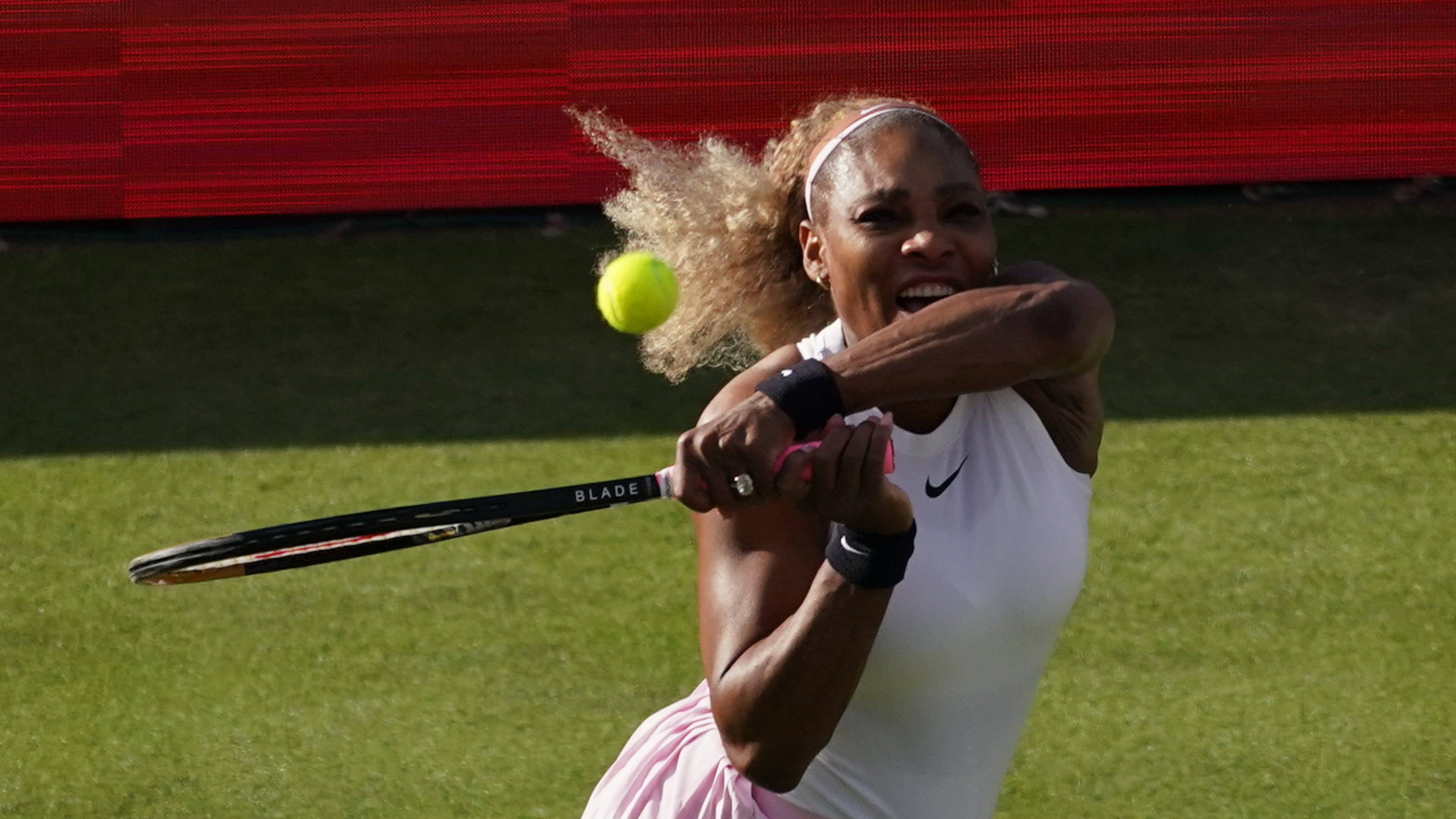 Serena Williams of the United States, hits a return as she and playing partner Victoria Mboko of Canada play against Nicole Melichar-Martinez of Canada and Erin Routliffe of New Zealand during their first round doubles match at the Queen's Club tennis championships in London, Tuesday, June 9, 2026. (AP Photo/Alberto Pezzali)