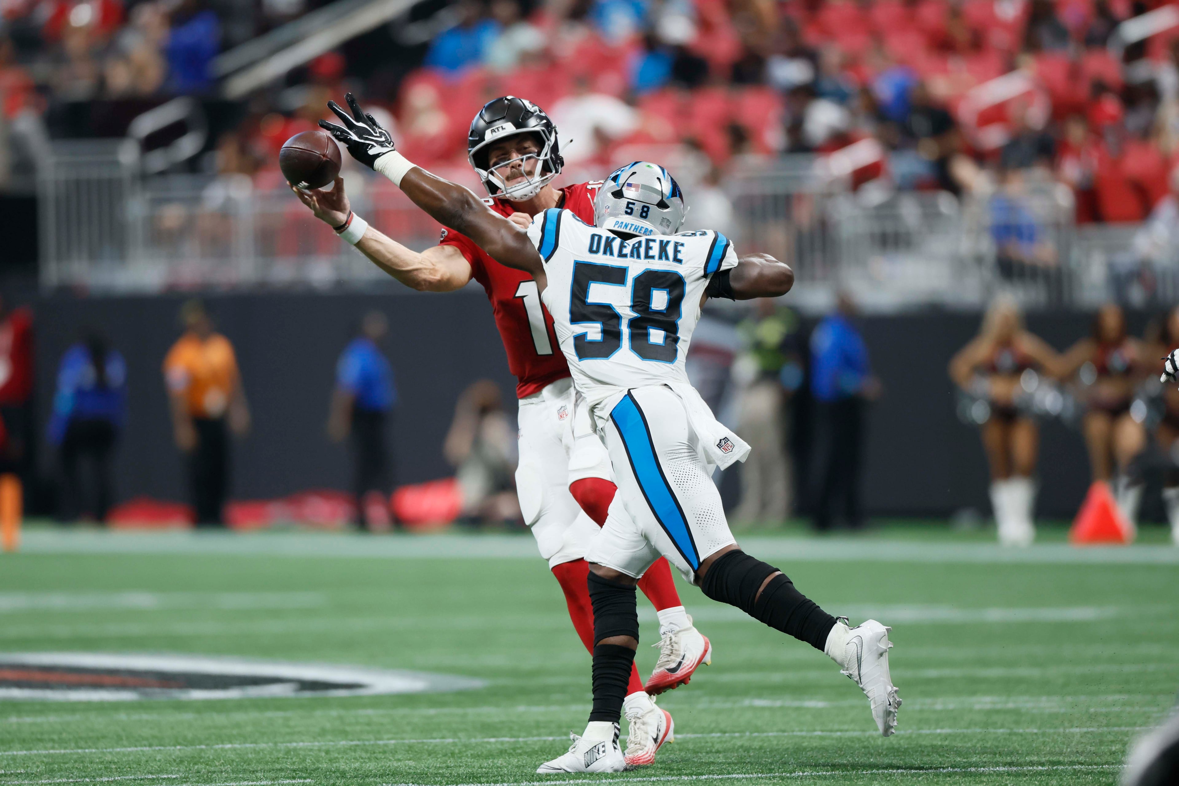 Atlanta Falcons quarterback Jack Strand (18) attempts a pass against Carolina Panthers linebacker Bobby Okereke (58) in the second half of an NFL game at Mercedes-Benz Stadium in Atlanta on Sunday, Sept. 20, 2026. (Miguel Martinez/AJC)