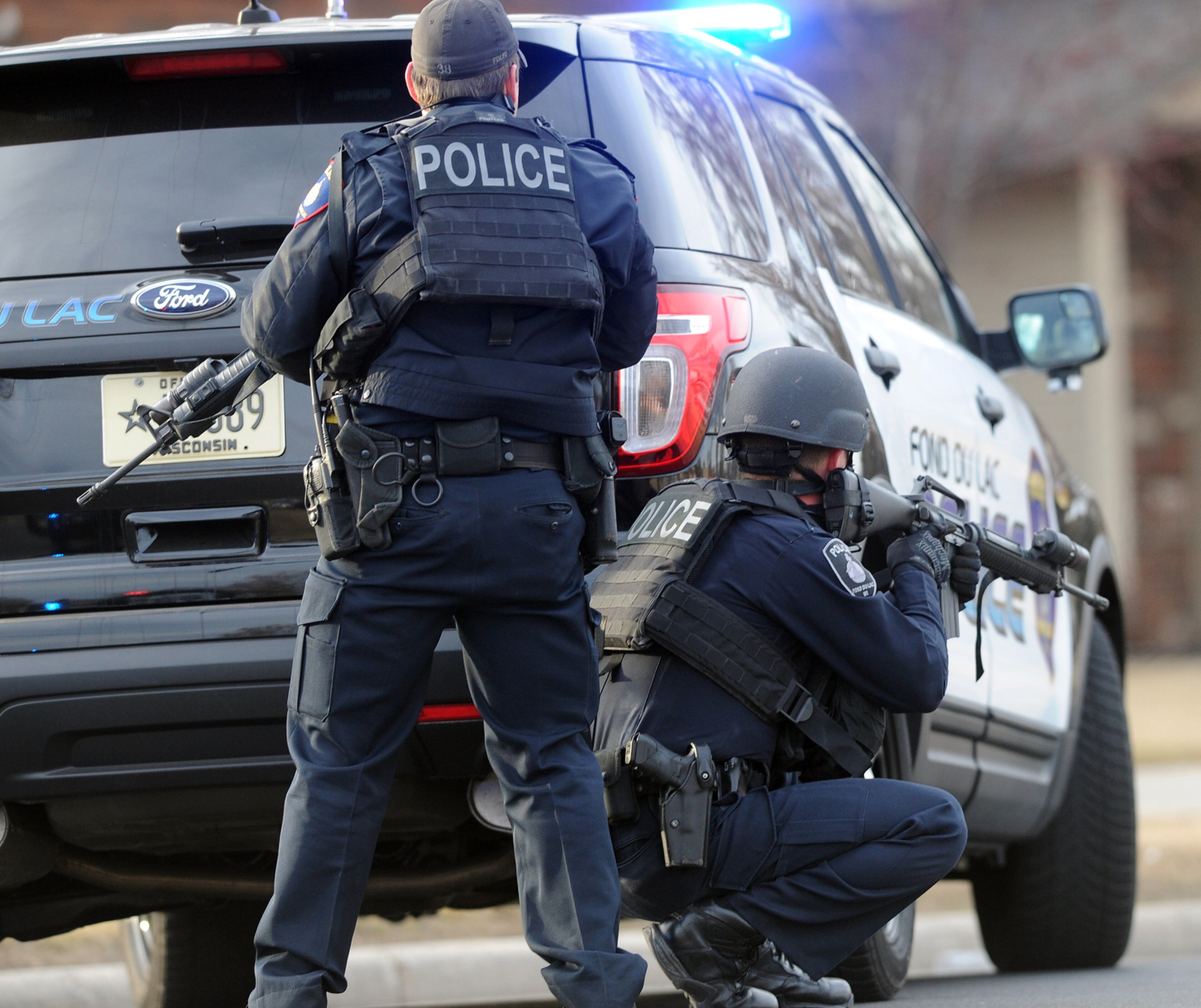 TROOPER SHOT--In this Tuesday, March 24, 2015 photo, officers work the scene where a Wisconsin State Patrol trooper just three months out of the academy died in a shootout with a bank robbery suspect also believed to have killed another motorist, in Fond du Lac, Wis. The suspect also died in the shootout. (AP Photo/The Reporter, Doug Raflik)