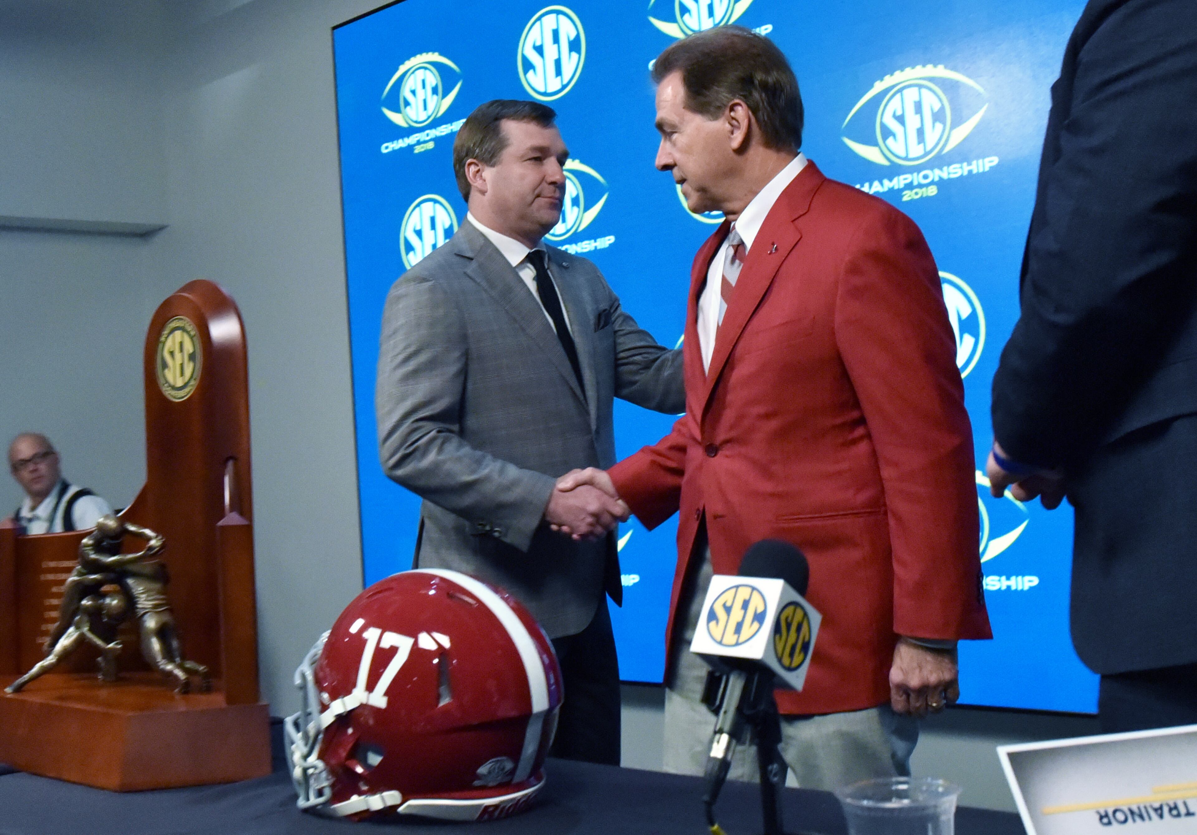 November 30, 2018 Atlanta - Georgia Head Coach Kirby Smart and Alabama Head Coach Nick Saba shake hands during a SEC press conference at Mercedes-Benz Stadium on Friday, November 30, 2018. HYOSUB SHIN / HSHIN@AJC.COM