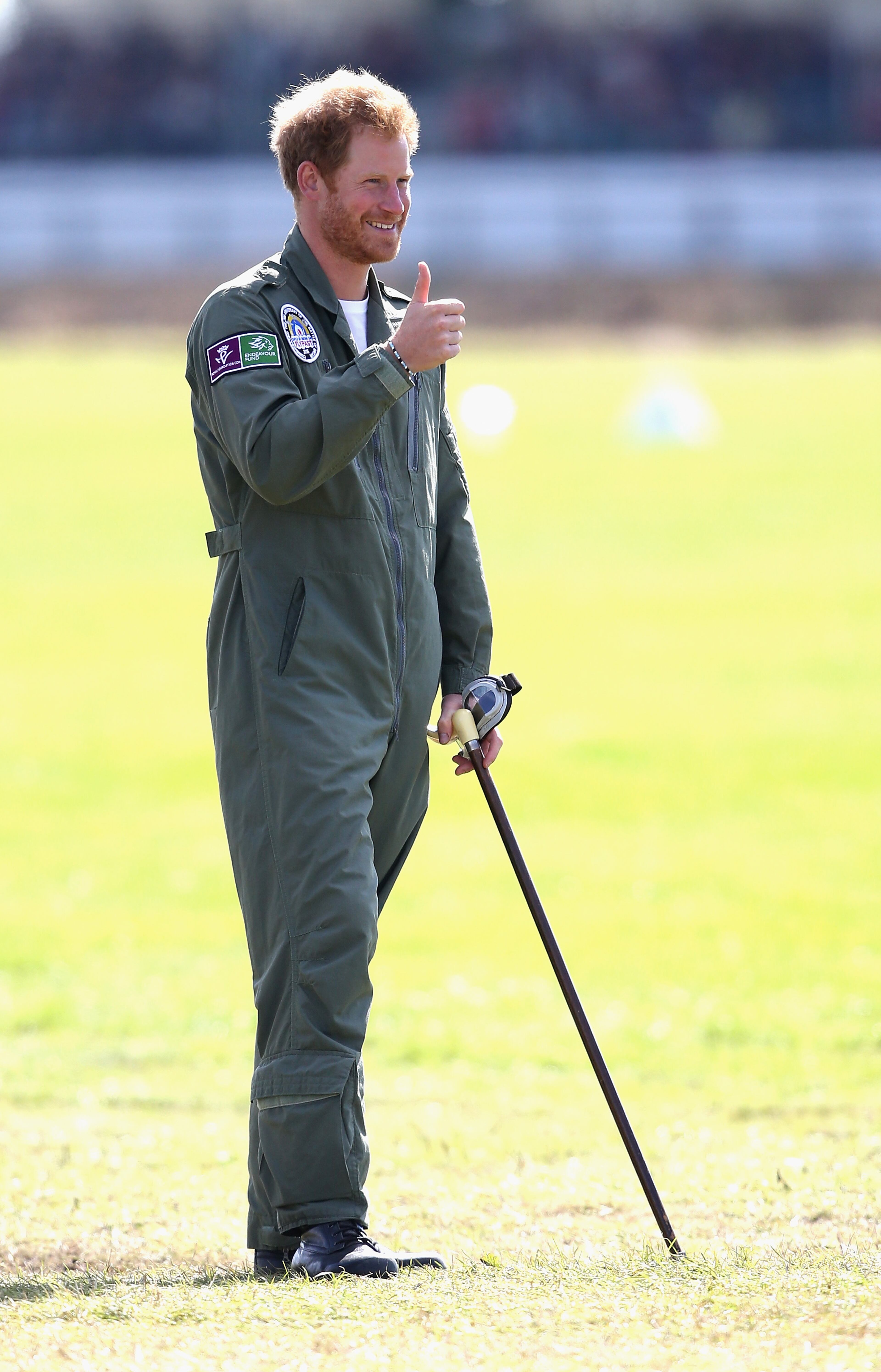 CHICHESTER, ENGLAND - SEPTEMBER 15: Prince Harry holds on to year old RAF veteranTom Neil's walking stick as he watches the Spitfires take off on the airfield at Goodwood Aerodrome during a Battle of Britain Flypast at Goodwood on September 15, 2015 in Chichester, England. Prince Harry gave up his seat in a Spitfire during today's Battle of Britain commemorations to allow veteran Tom to take his place after one of the planes was found to have a mechanical fault. The 75th Anniversary of the Battle of Britain is being marked by a historic flypast that brings more Battle of Britain aircraft together than ever before as a show of thanks to 'the few' and the sacrifices they made. (Photo by Chris Jackson/Getty Images)