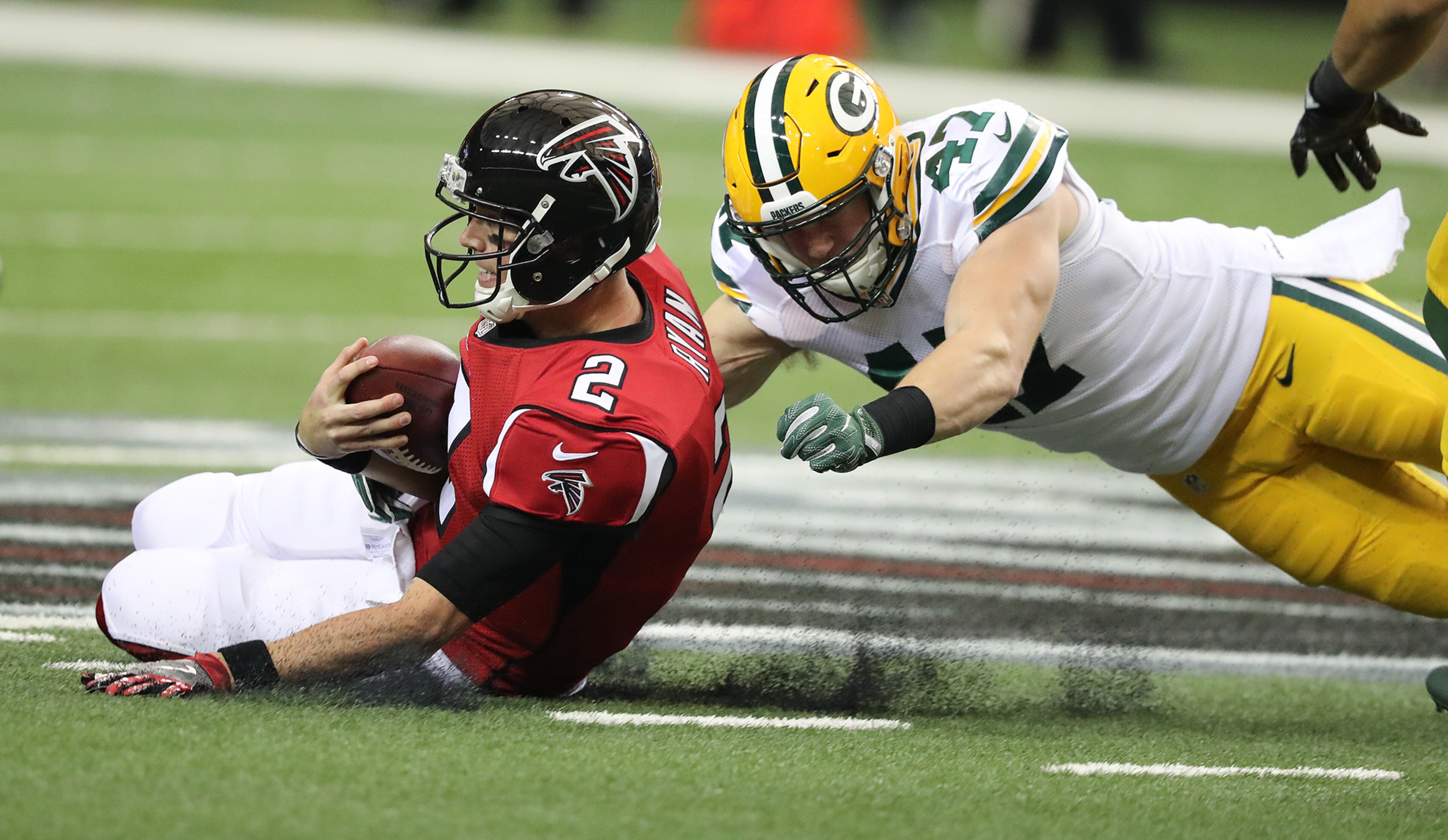 October 30, 2016 ATLANTA: Falcons quarterback Matt Ryan slides to the turf on a quarterback keeper as Packers linebacker Jake Ryan arrives during the first half in an NFL football game on Sunday, Oct. 30, 2016, in Atlanta. Curtis Compton /ccompton@ajc.com