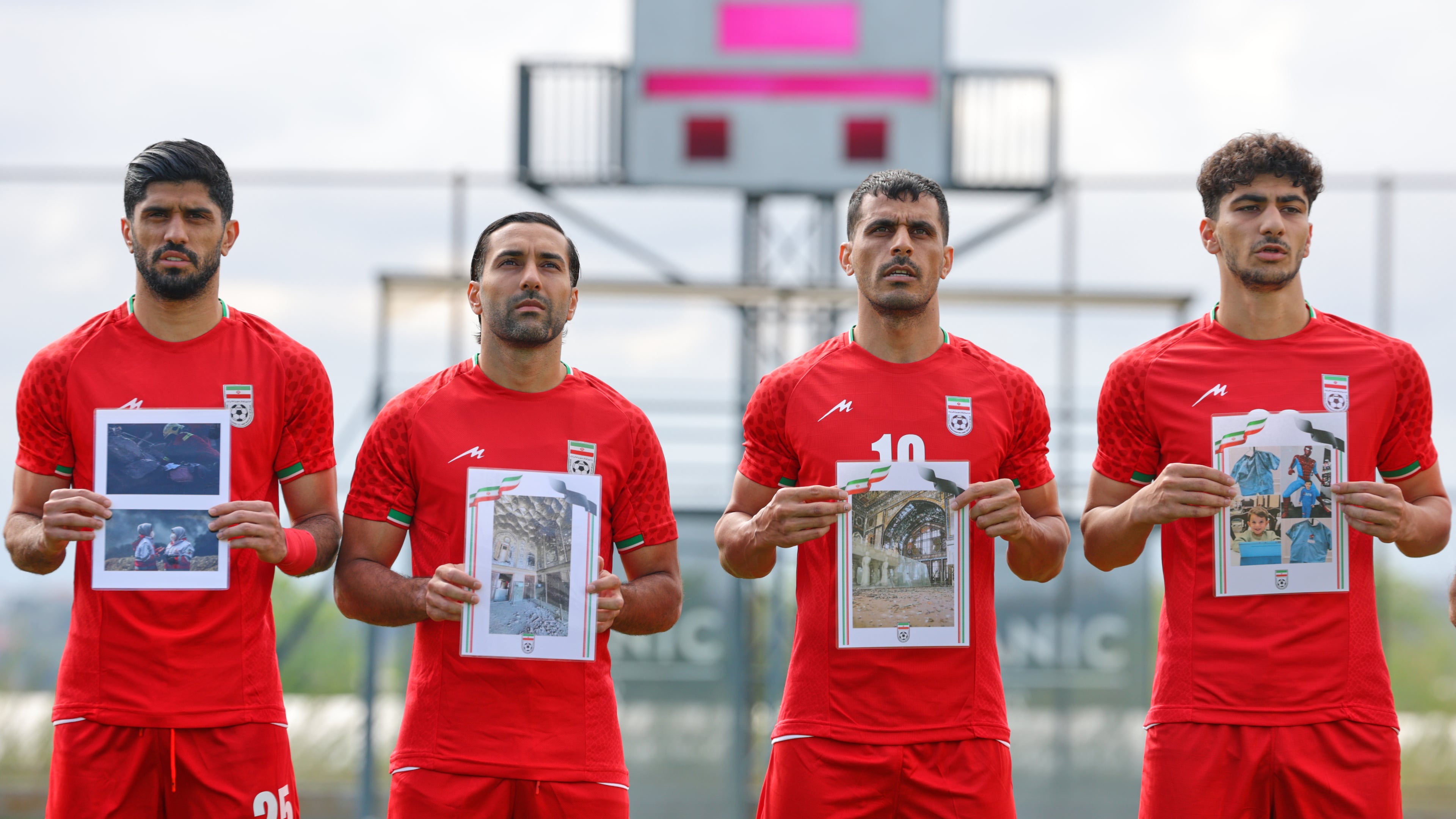 Iran's players sing the national anthem, holding pictures of children allegedly killed in U.S. and Israel strikes in Iran, before a friendly soccer match between Iran and Costa Rica, in Antalya, southern Turkey, Tuesday, March 31, 2026. (AP Photo/Riza Ozel)