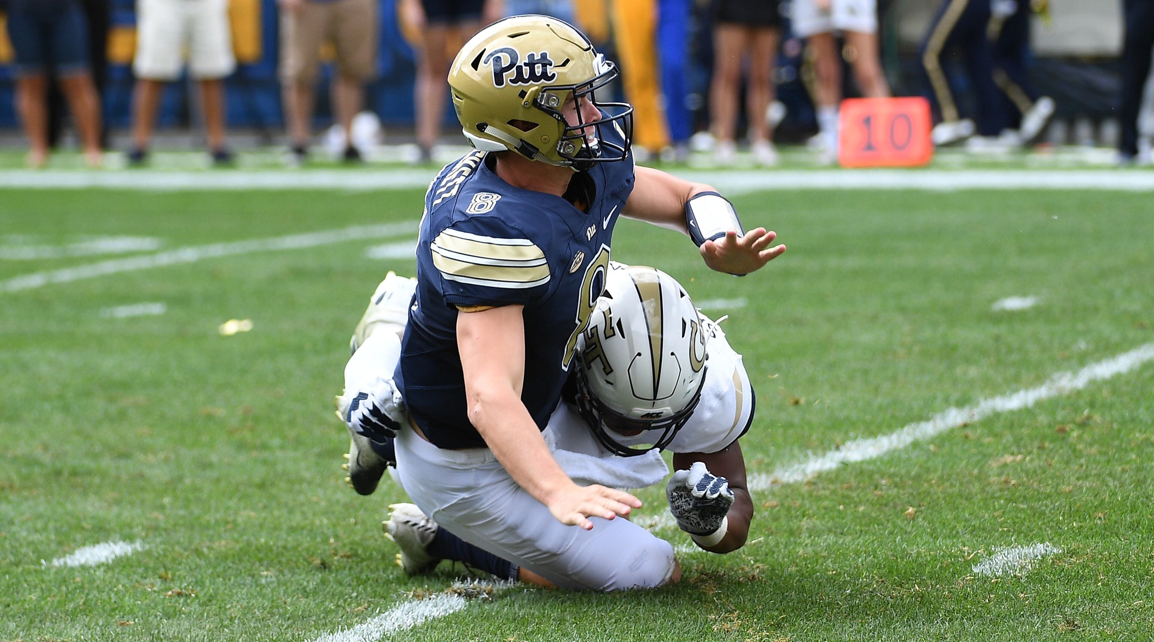 PITTSBURGH, PA - SEPTEMBER 15: Kenny Pickett #8 of the Pittsburgh Panthers is hit after throwing by Anree Saint-Amour #94 of the Georgia Tech Yellow Jackets in the first half during the game at Heinz Field on September 15, 2018 in Pittsburgh, Pennsylvania. (Photo by Justin Berl/Getty Images)
