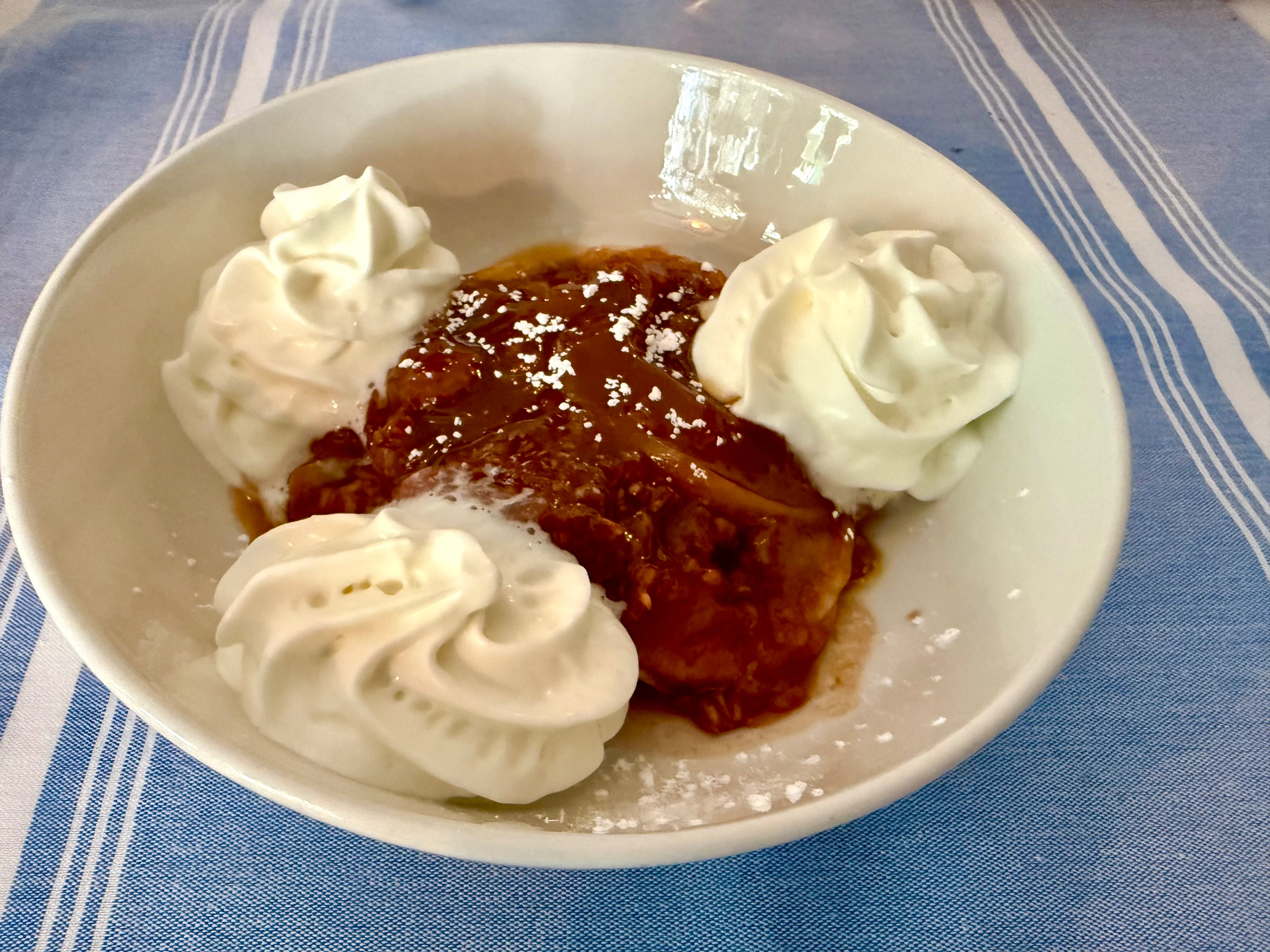 A classic French tarte Tatin gets its caramelized apple finish at Decatur's Café Alsace. (Angela Hansberger for the AJC)