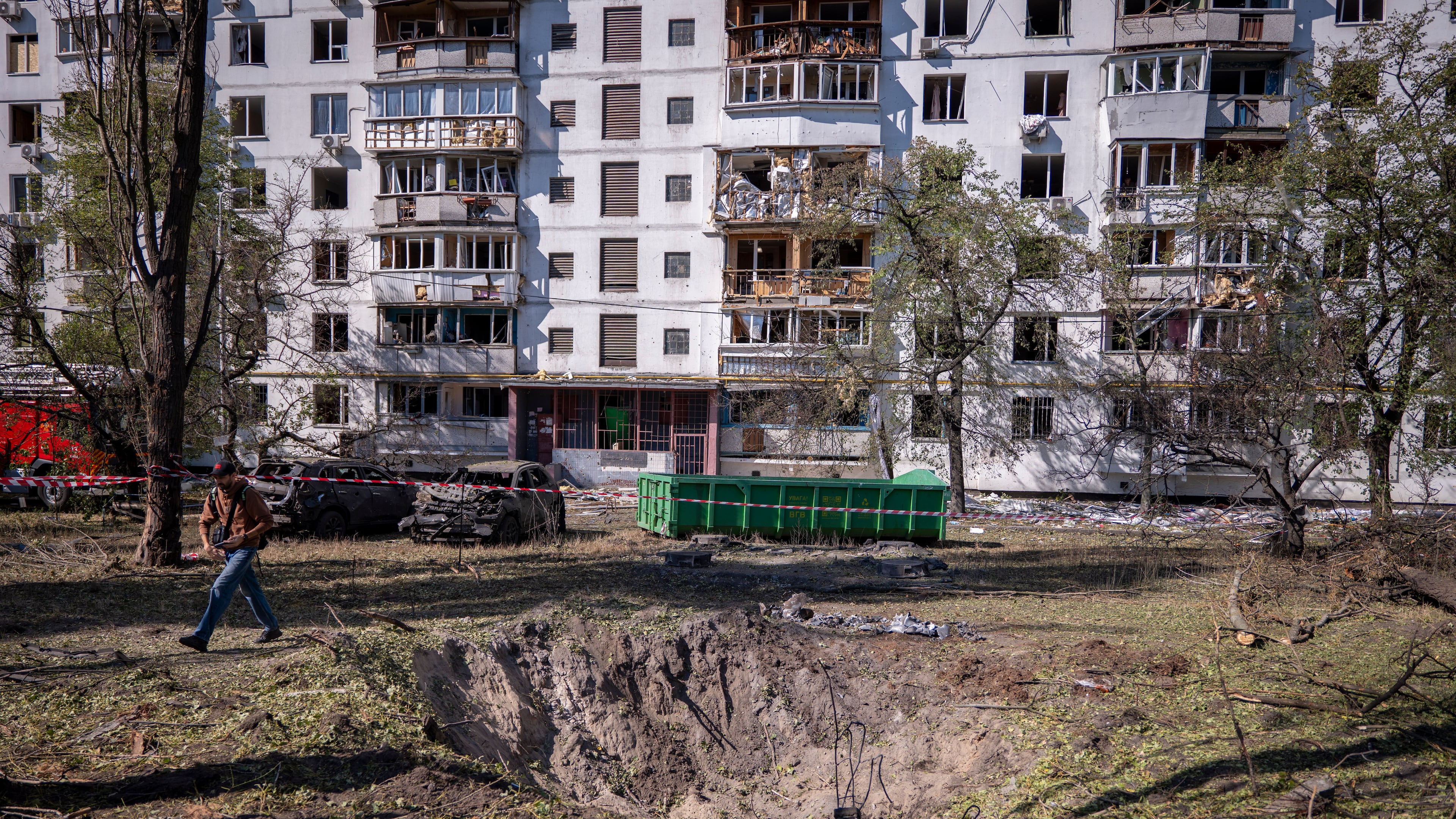 A missile crater is seen in the foreground, of a damaged apartment building following Russia's air attack in Kyiv, Ukraine, Thursday, Sept. 17, 2026. (AP Photo/Dan Bashakov)