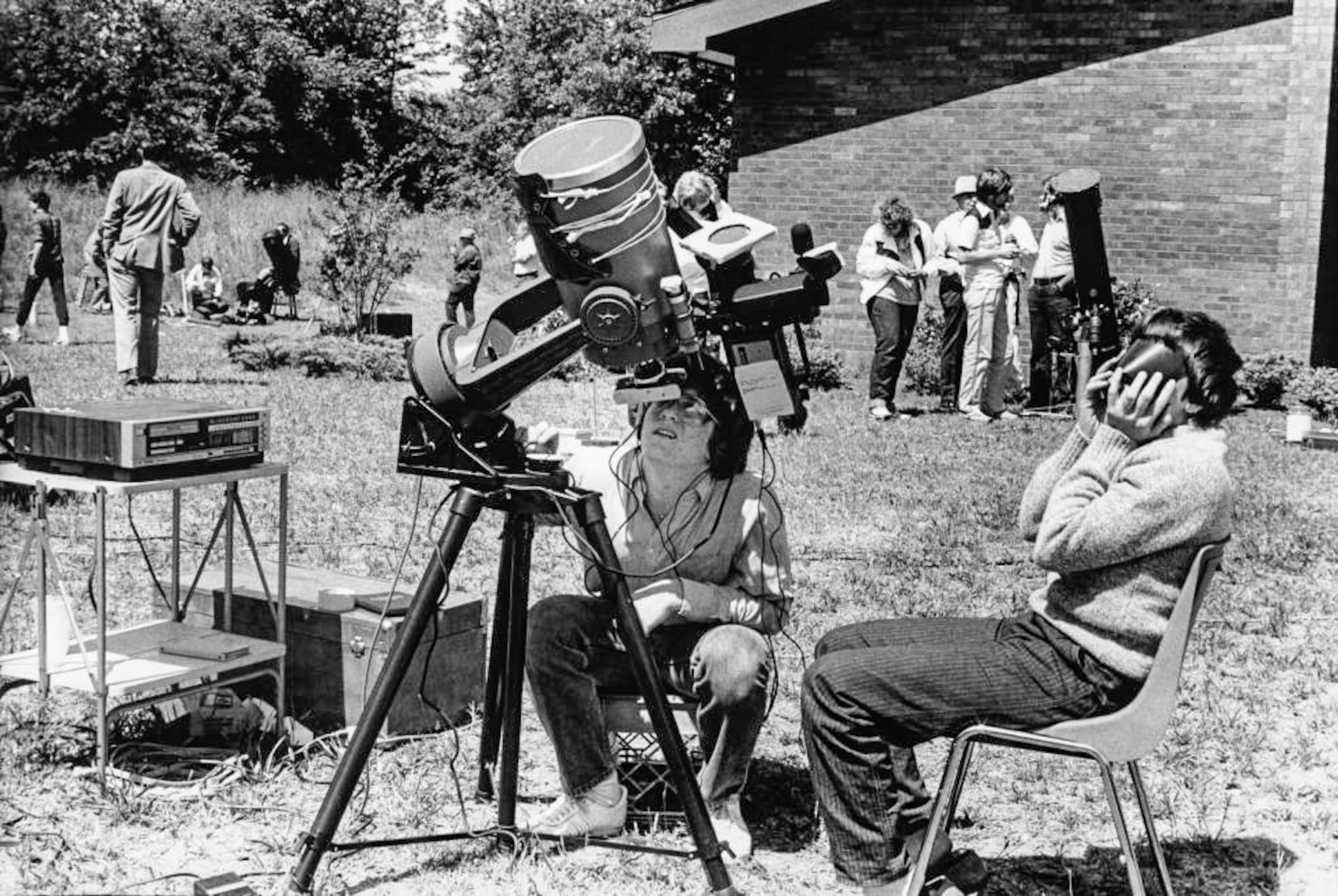 Astronomers watching the solar eclipse through telescopes and special lenses, somewhere in Fulton County on May 30, 1984.
