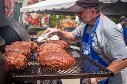 Peter Tiller checks on his smoked lamb during the 29th annual Marietta Greek Festival in Marietta on Saturday, May 18, 2019. (Steve Schaefer for the AJC)
