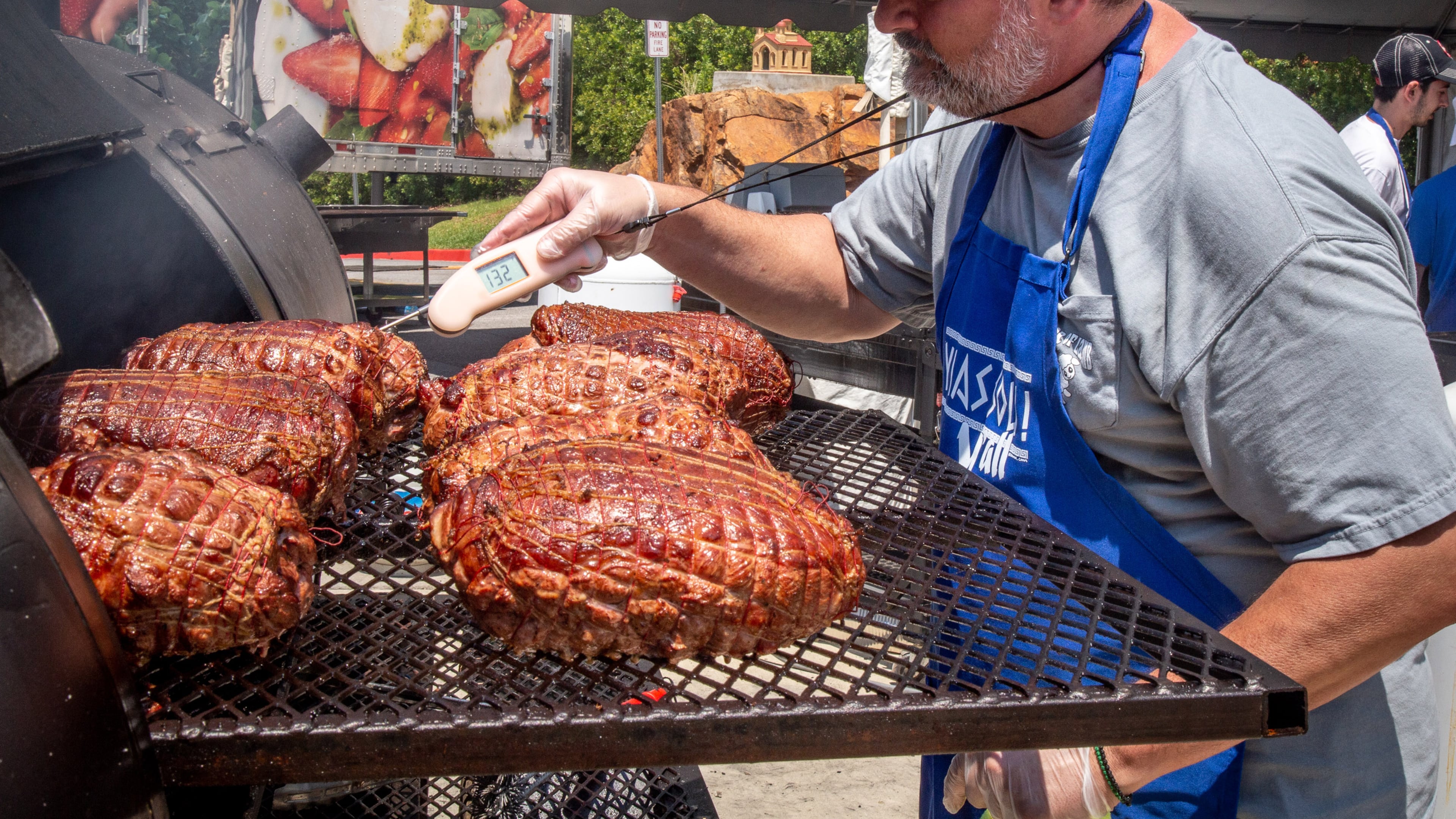 Peter Tiller checks on his smoked lamb during the 29th annual Marietta Greek Festival in Marietta on Saturday, May 18, 2019. (Steve Schaefer for the AJC)