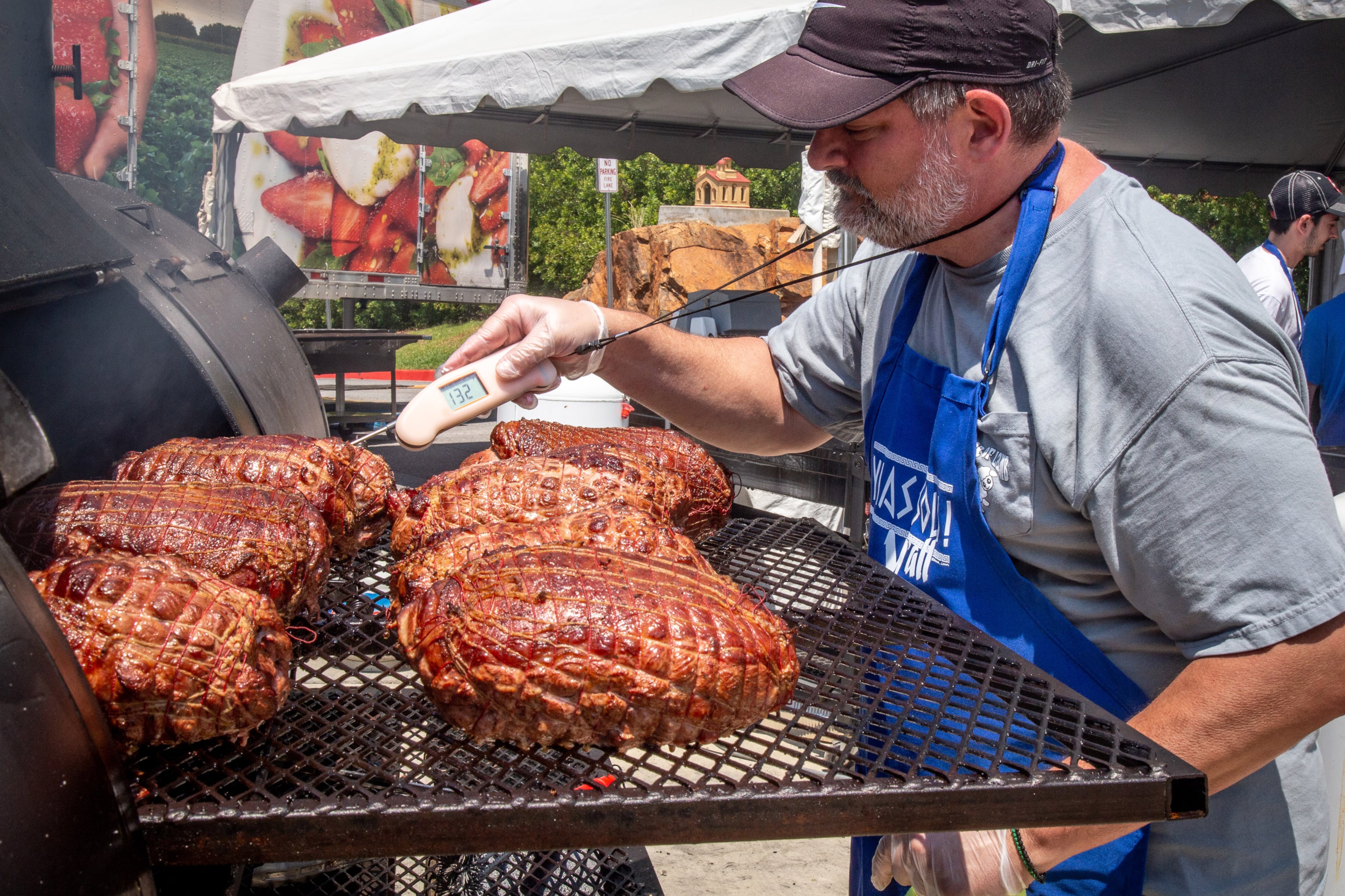 Peter Tiller checks on his smoked lamb during the 29th annual Marietta Greek Festival in Marietta on Saturday, May 18, 2019. (Steve Schaefer for the AJC)