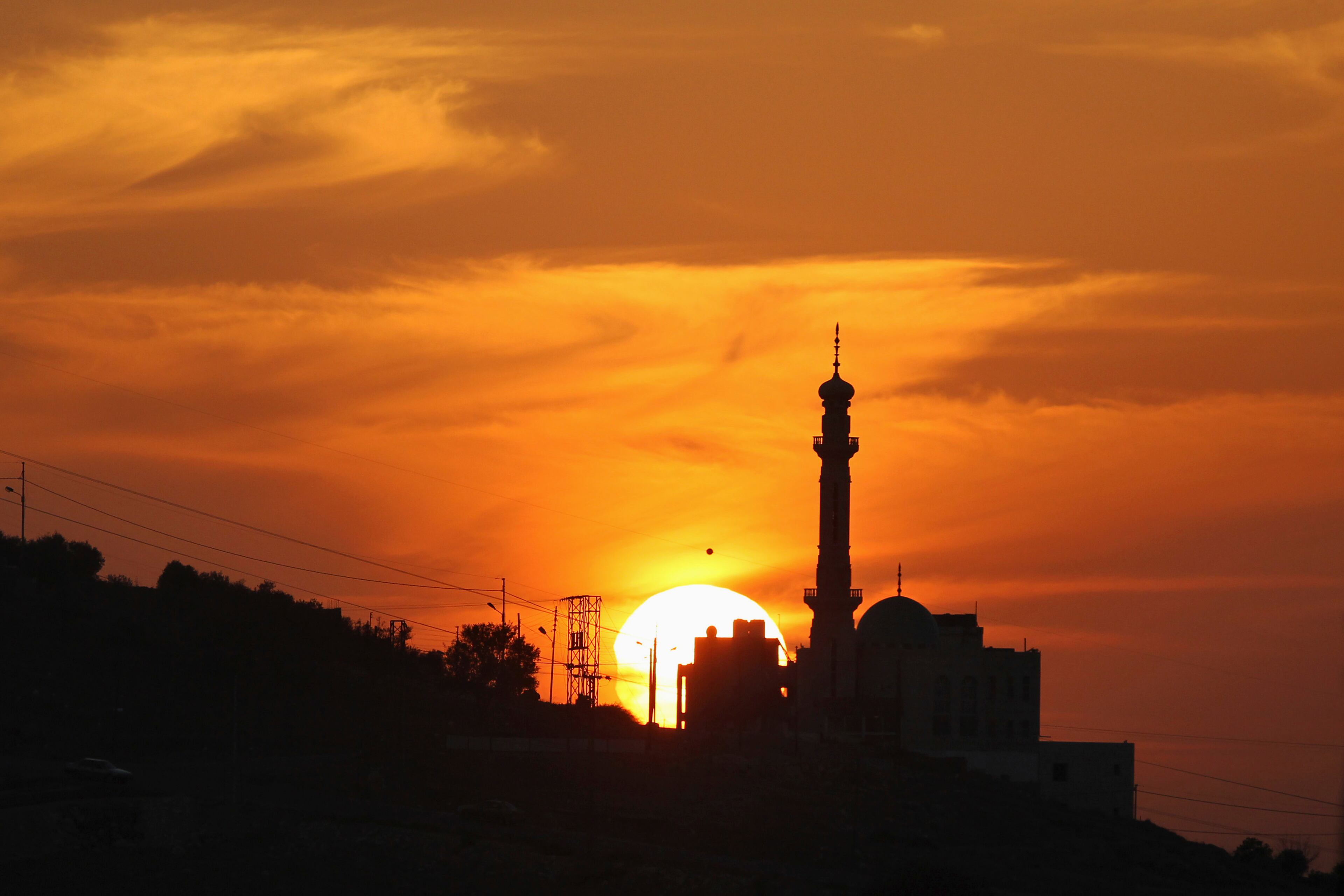 A partially-eclipsed sun is seen in Amman November 3, 2013. Skywatchers across the world are in for a treat Sunday as the final solar eclipse of 2013 takes on a rare hybrid form. REUTERS/Muhammad Hamed