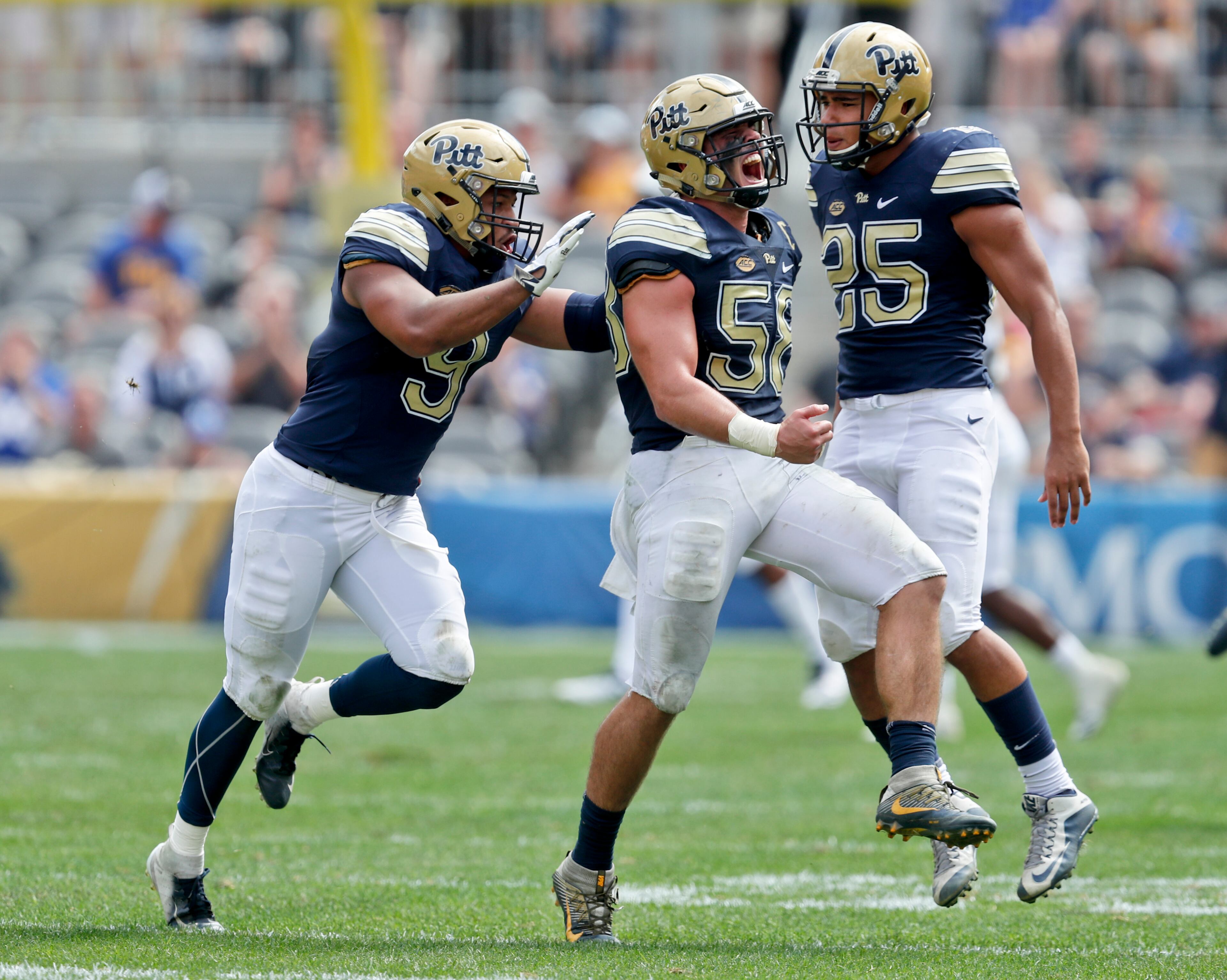 Pittsburgh linebacker Quintin Wirginis, center celebrates with linebackers Saleem Brightwell (9) and Elijah Zeise (25) after sacking Georgia Tech quarterback TaQuon Marshall in the second quarter of an NCAA football game, Saturday, Sept. 15, 2018, in Pittsburgh. (AP Photo/Keith Srakocic)