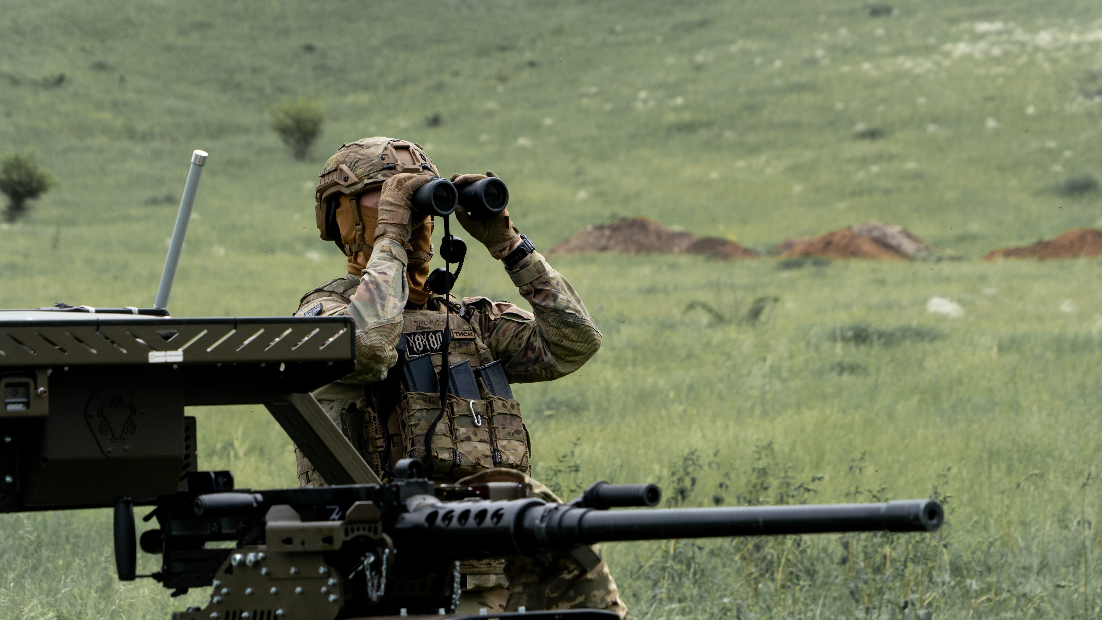 A Ukrainian serviceman of the Cerberus Ground Unmanned Systems Company of the 60th Separate Mechanized Brigade, Third Army Corps, conducts a drill with a combat ground drone during a training at the polygon in Kharkiv region, Ukraine, Sunday, May 24, 2026. (AP Photo/Andrii Marienko)