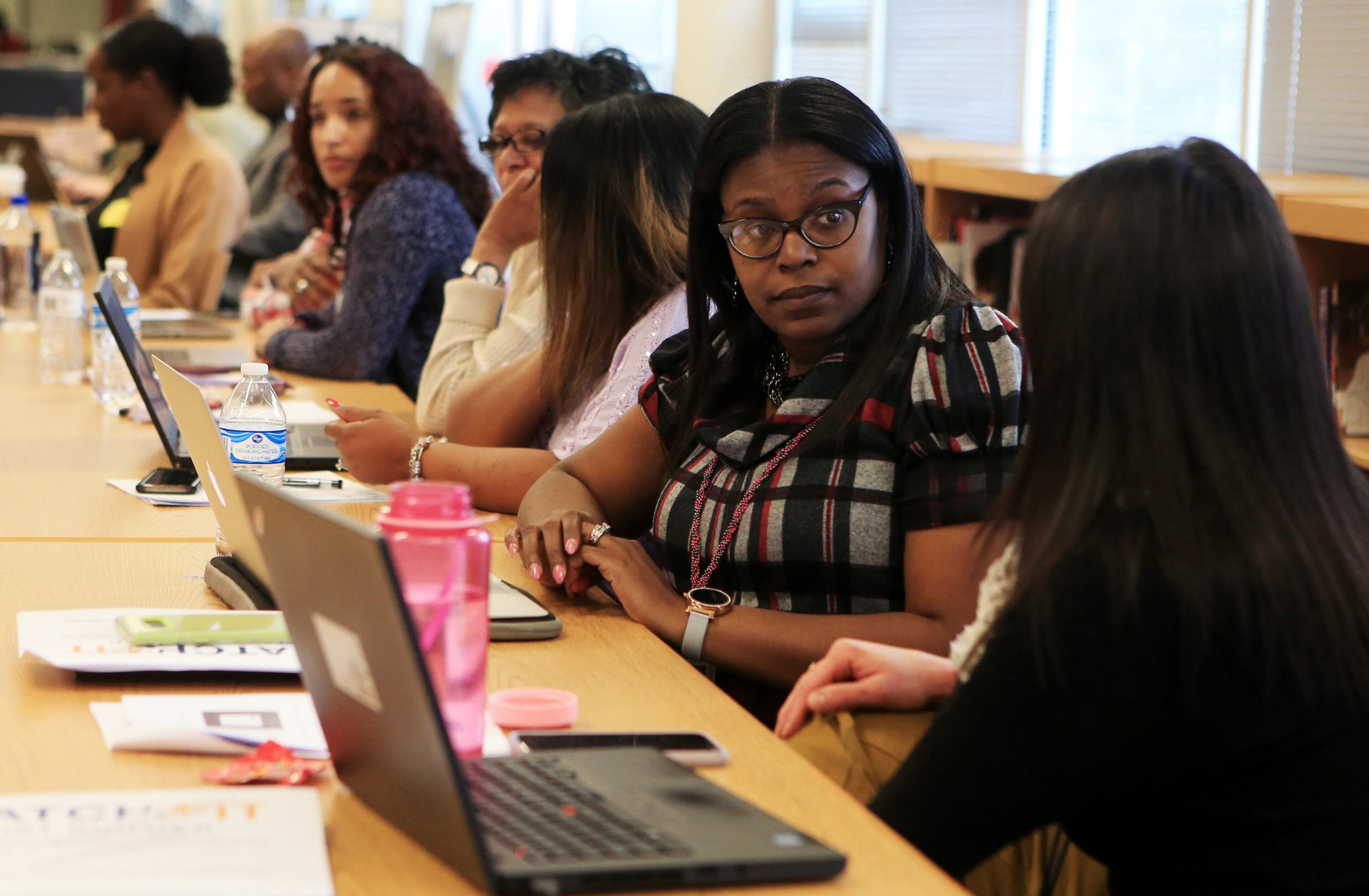 Shaketha Blankenship (left), counselor for Atlanta Public Schools, talks with Tina Pellechia (right), counselor for Atlanta Public Schools, during a training session on how to use a new computer-based college search tool on Monday, Jan. 27, 2020, at Maynard Jackson High School in Atlanta. (Christina Matacotta/crmatacotta@gmail.com)