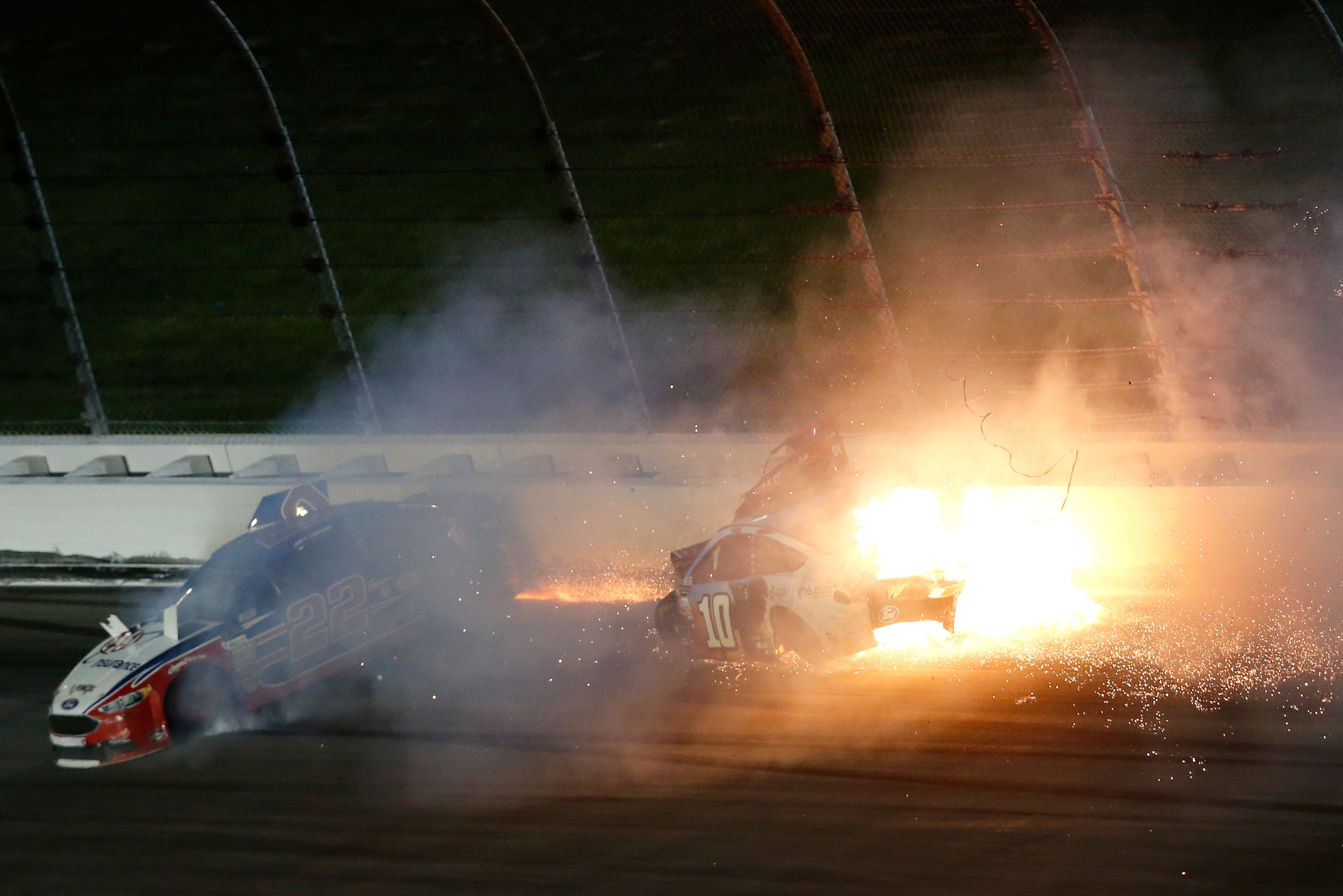 KANSAS CITY, KS - MAY 13: Joey Logano, driver of the #22 AAA Insurance Ford, and Danica Patrick, driver of the #10 Wonder Woman/One Cure Ford, crash during the Monster Energy NASCAR Cup Series Go Bowling 400 at Kansas Speedway on May 13, 2017 in Kansas City, Kansas. (Photo by Sean Gardner/Getty Images)