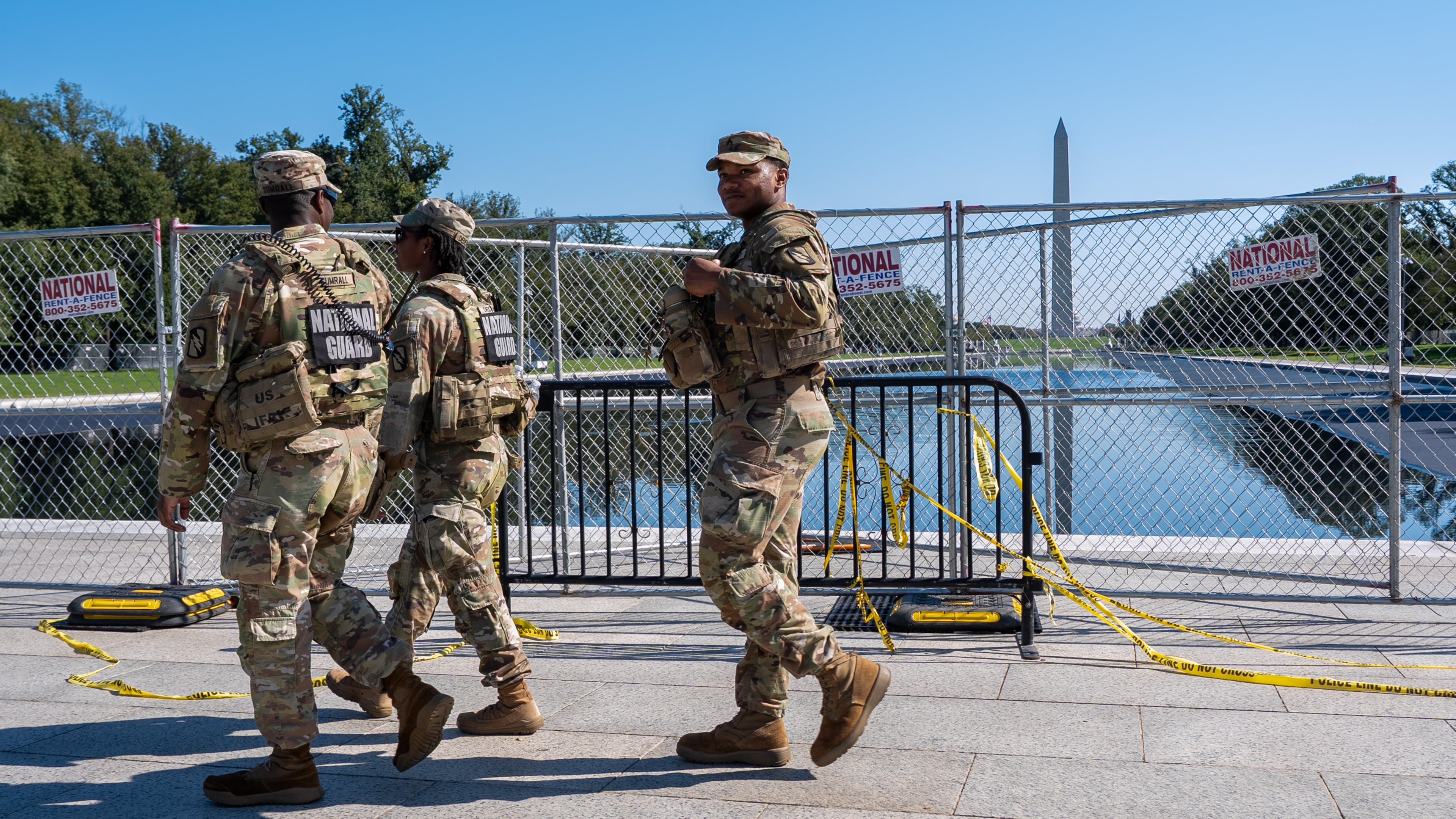 Members of the National Guard walk past the Lincoln Memorial Reflecting Pool, where some water can be seen, Tuesday, Oct. 13, 2026, in Washington. (AP Photo/Jacquelyn Martin)