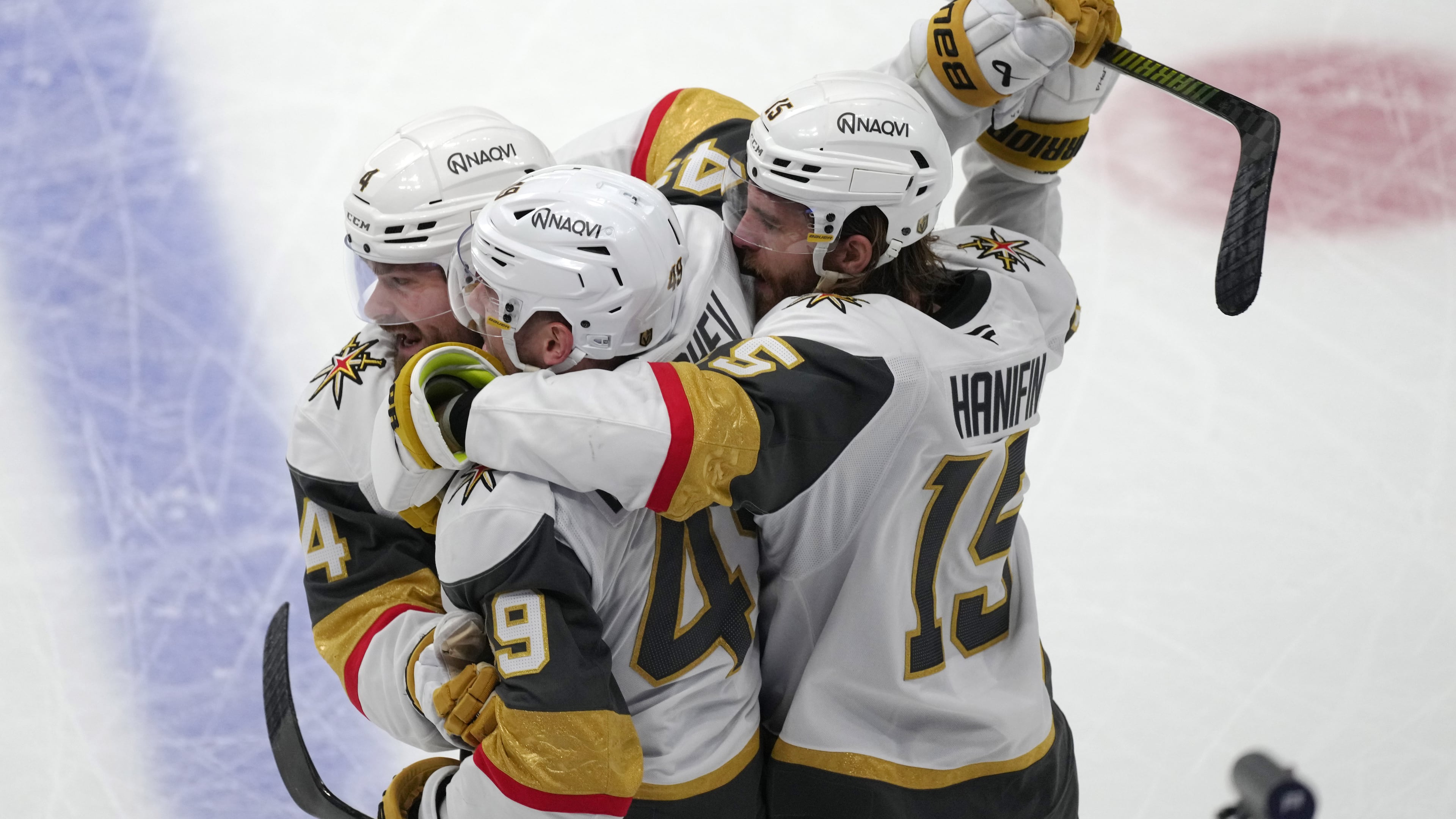 Vegas Golden Knights left wing Ivan Barbashev, center, is congratulated by Vegas Golden Knights defensemen Rasmus Andersson, left, and Noah Hanifin during the third period in Game 2 of the Western Conference finals NHL hockey Stanley Cup playoff series against the Colorado Avalanche Friday, May 22, 2026, in Denver. (AP Photo/David Zalubowski)