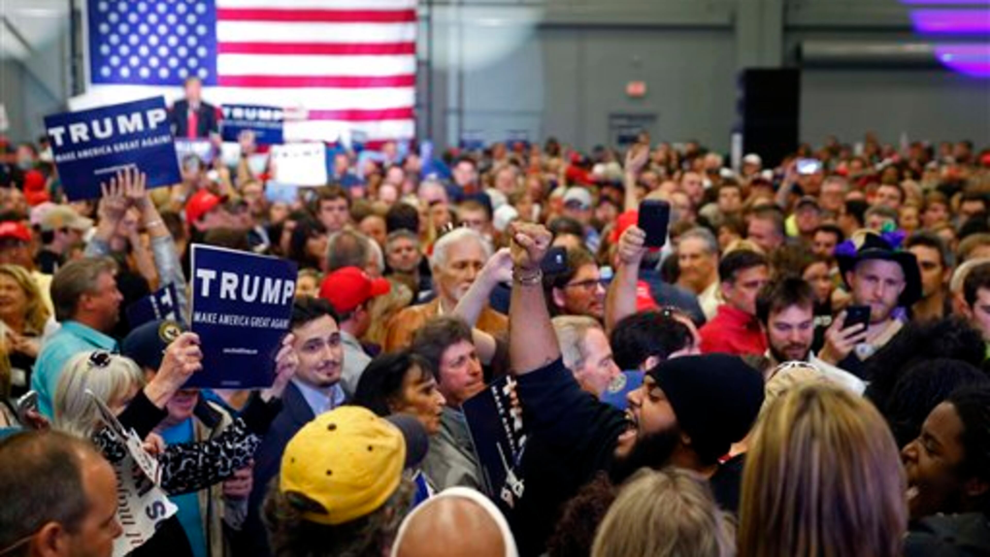 A protester chanting "Black Lives Matter" is escorted away as Republican presidential candidate Donald Trump, background, speaks at a campaign rally in New Orleans, Friday, March 4, 2016. (AP Photo/Gerald Herbert)