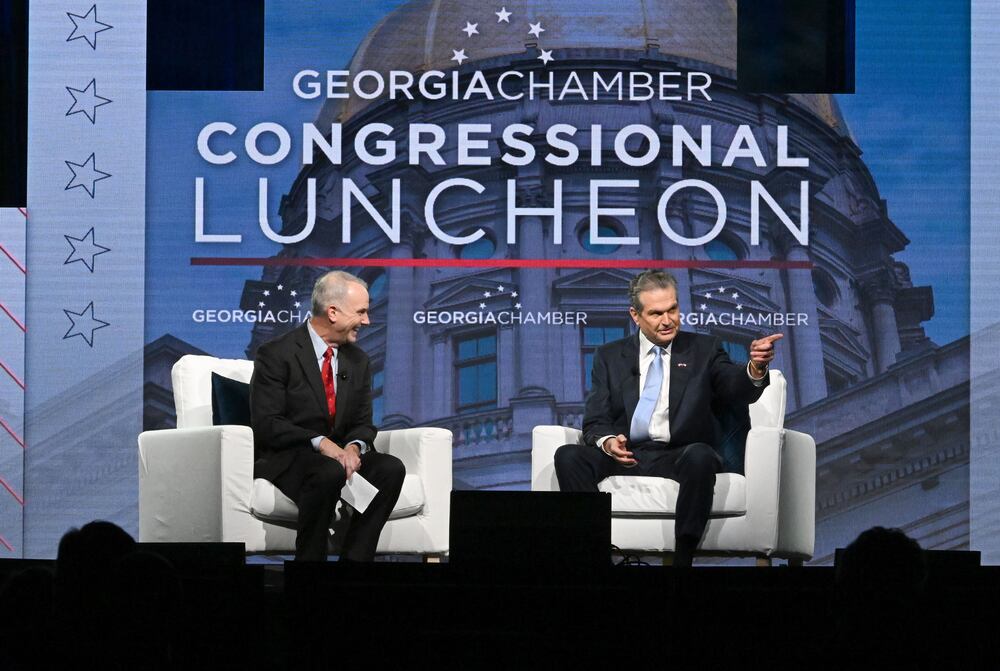 Republican nominee for governor Rick Jackson, right, speaks as moderator Brian Robinson listens during the Georgia Chamber Congressional Luncheon in Athens last month. (Hyosub Shin/AJC)