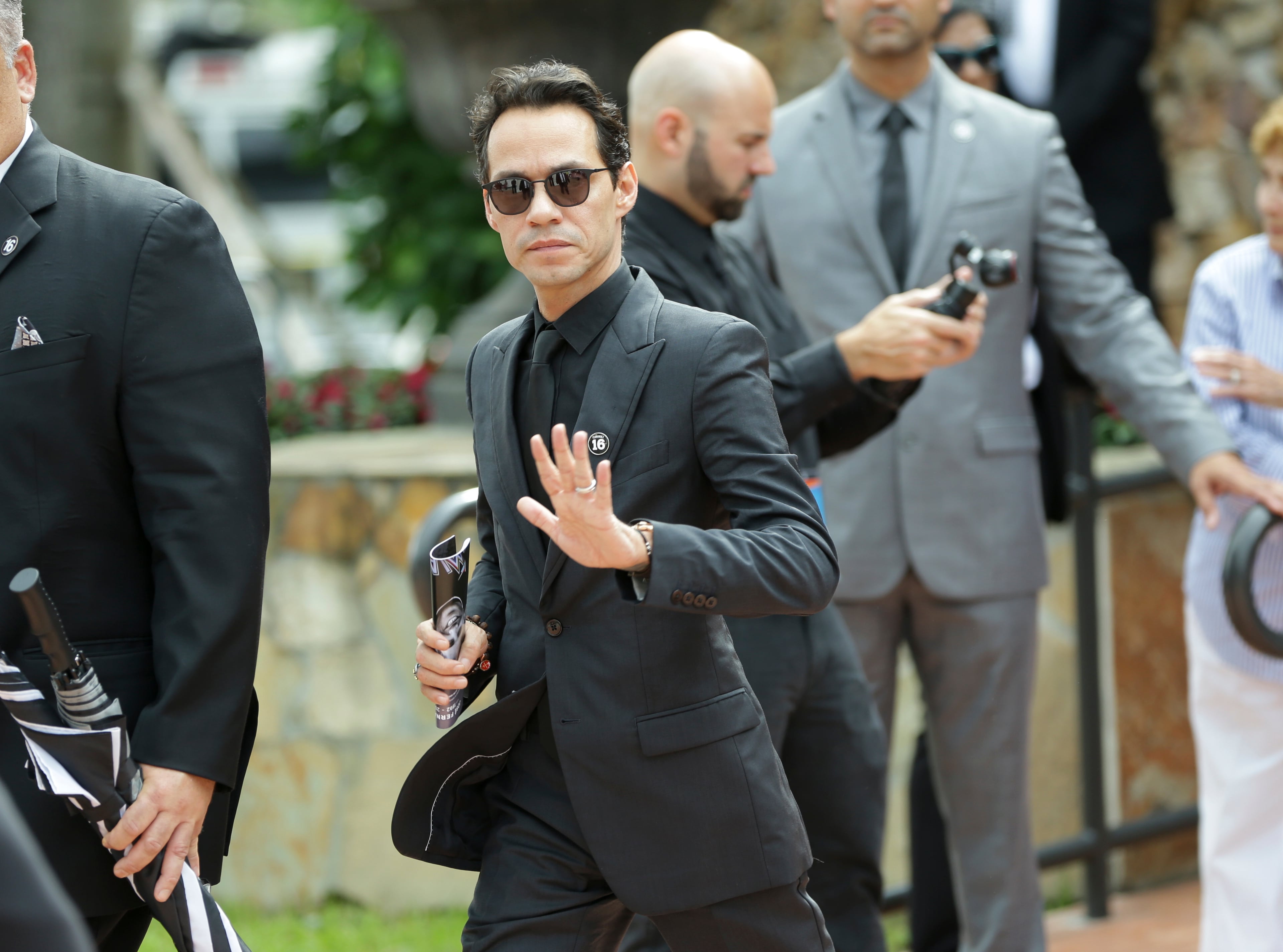 Musician Marc Anthony waves as he leaves a memorial service for Miami Marlins pitcher Jose Fernandez, at St. Brendan's Catholic Church, Thursday, Sept. 29, 2016, in Miami. Fernandez was killed in a boating accident Sunday along with two friends. (AP Photo/Lynne Sladky)