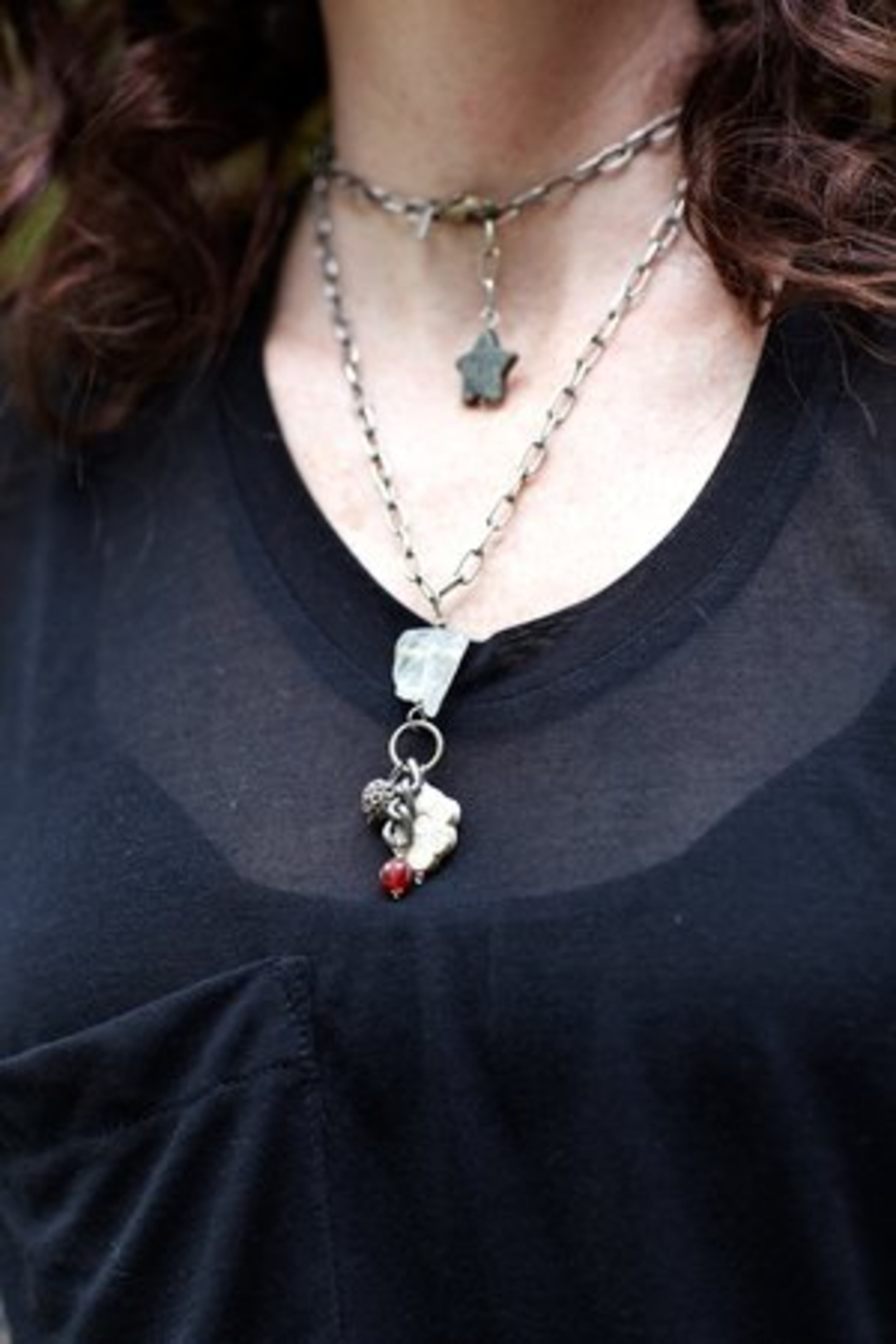 Saunders accessorizes with a stone and crystal chain link necklace from Mark Edge.