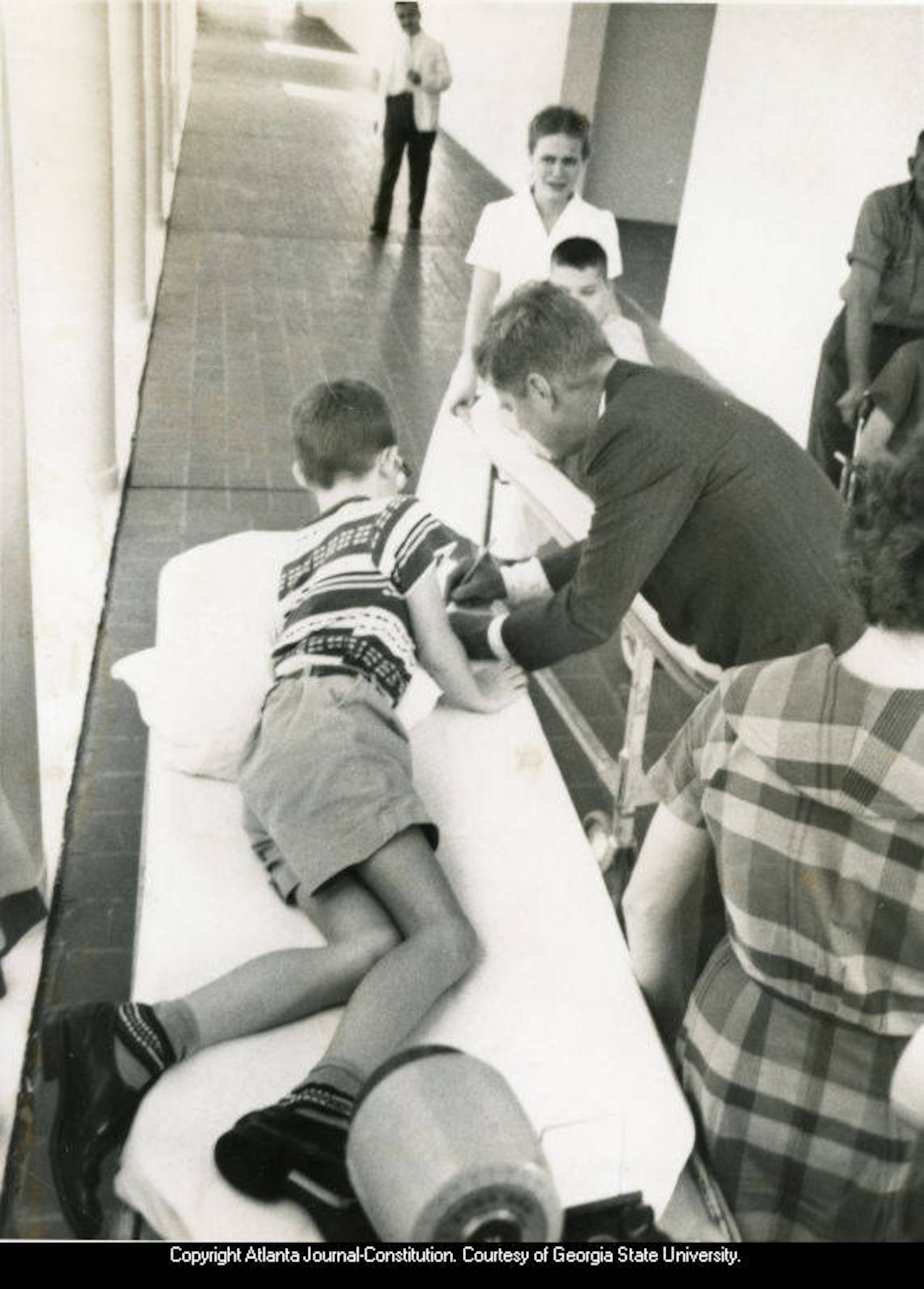 John F. Kennedy, signing autographs for a patients at the Georgia Warm Springs Foundation, Warm Springs, Georgia, during the presidential campaign, October 10, 1960. Atlanta Journal-Constitution Photographic Archive