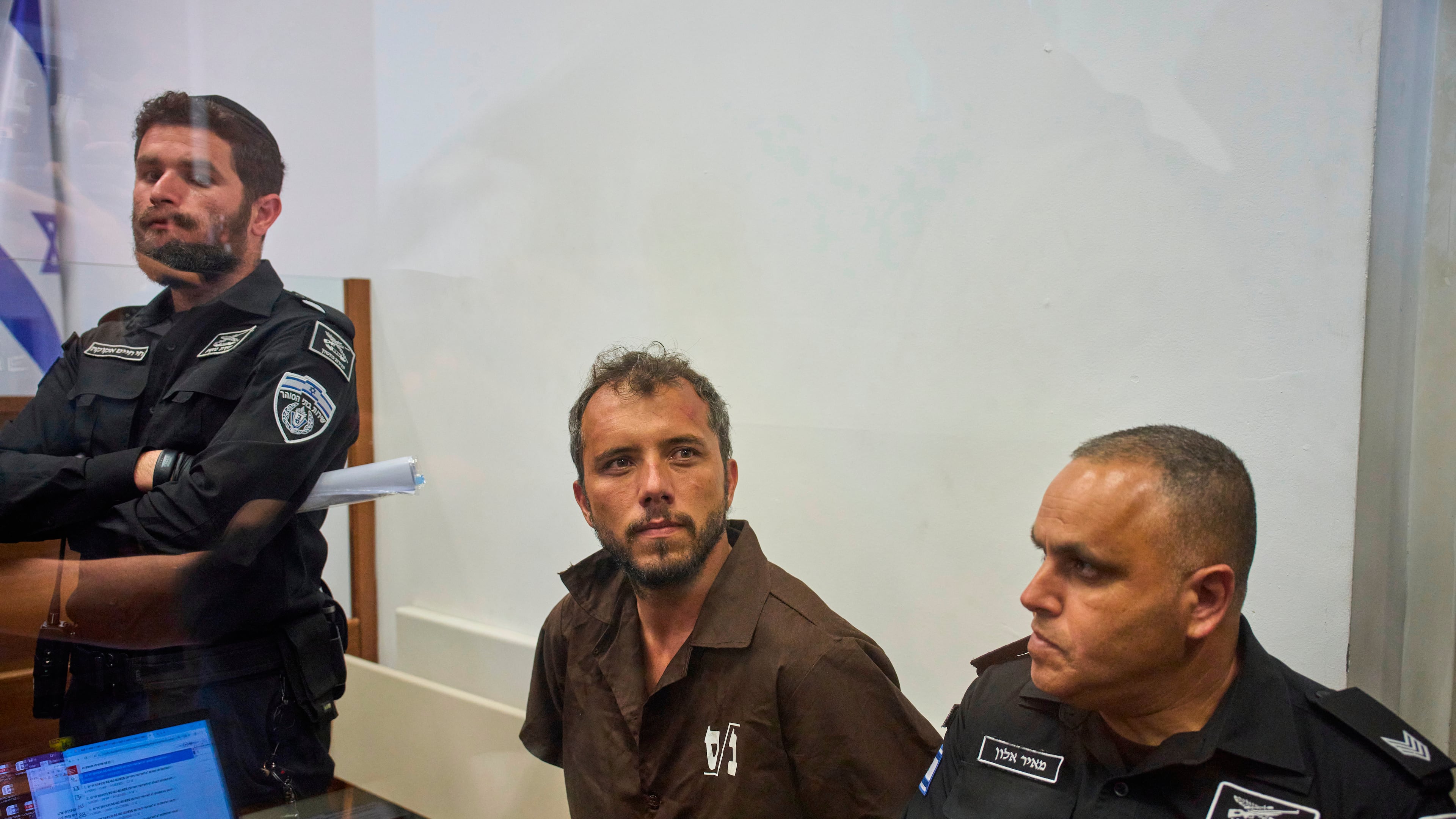 Brazilian activist Thiago Ávila, center, a member of the Global Sumud Flotilla, is escorted by prison service guards to a hearing at the District Court in Ashkelon, Israel, on Sunday, May 3, 2026. (AP Photo/Ohad Zwigenberg)