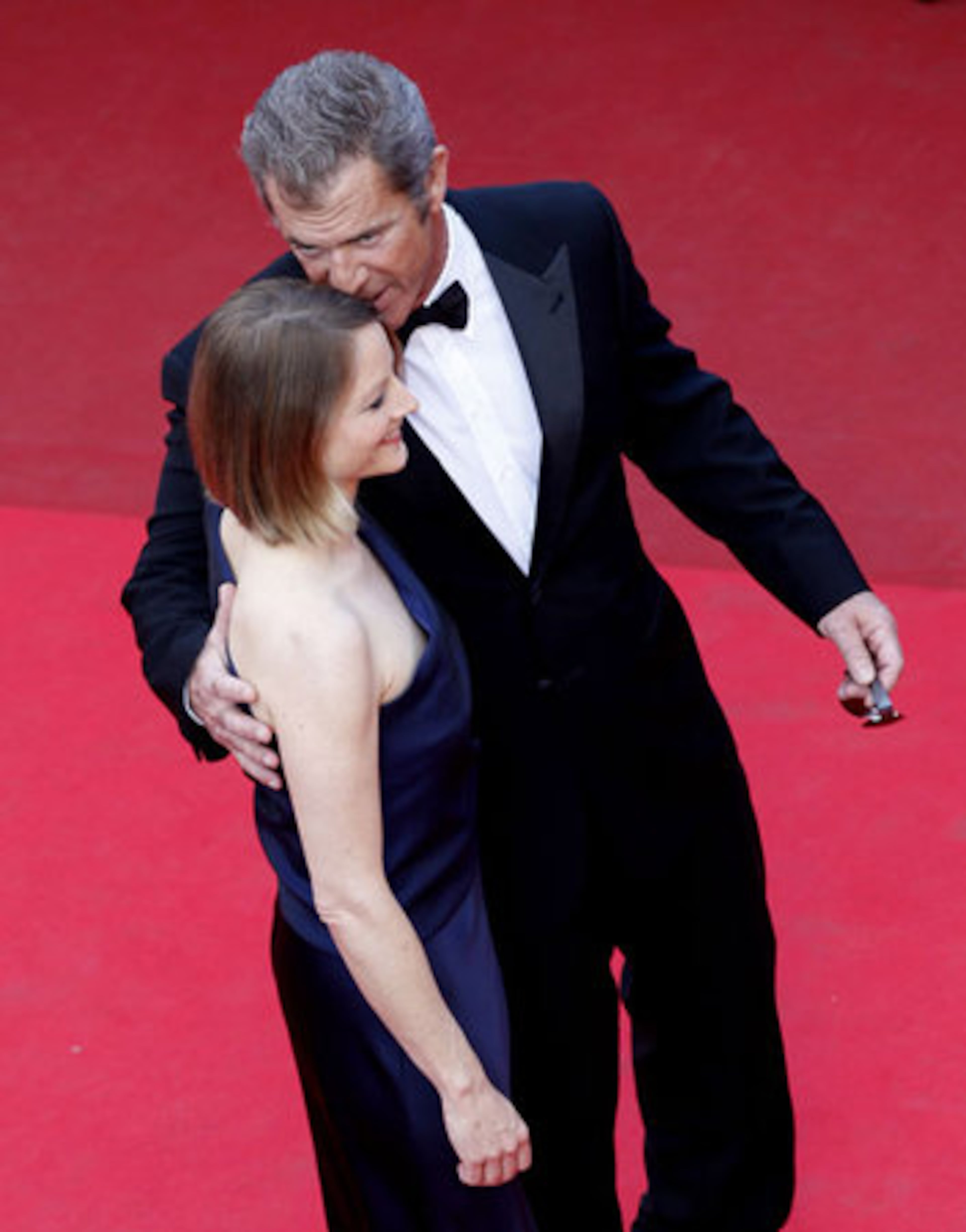 In a tender moment Gibson leans in to whisper to "The Beaver" director and actress Jodie Foster.