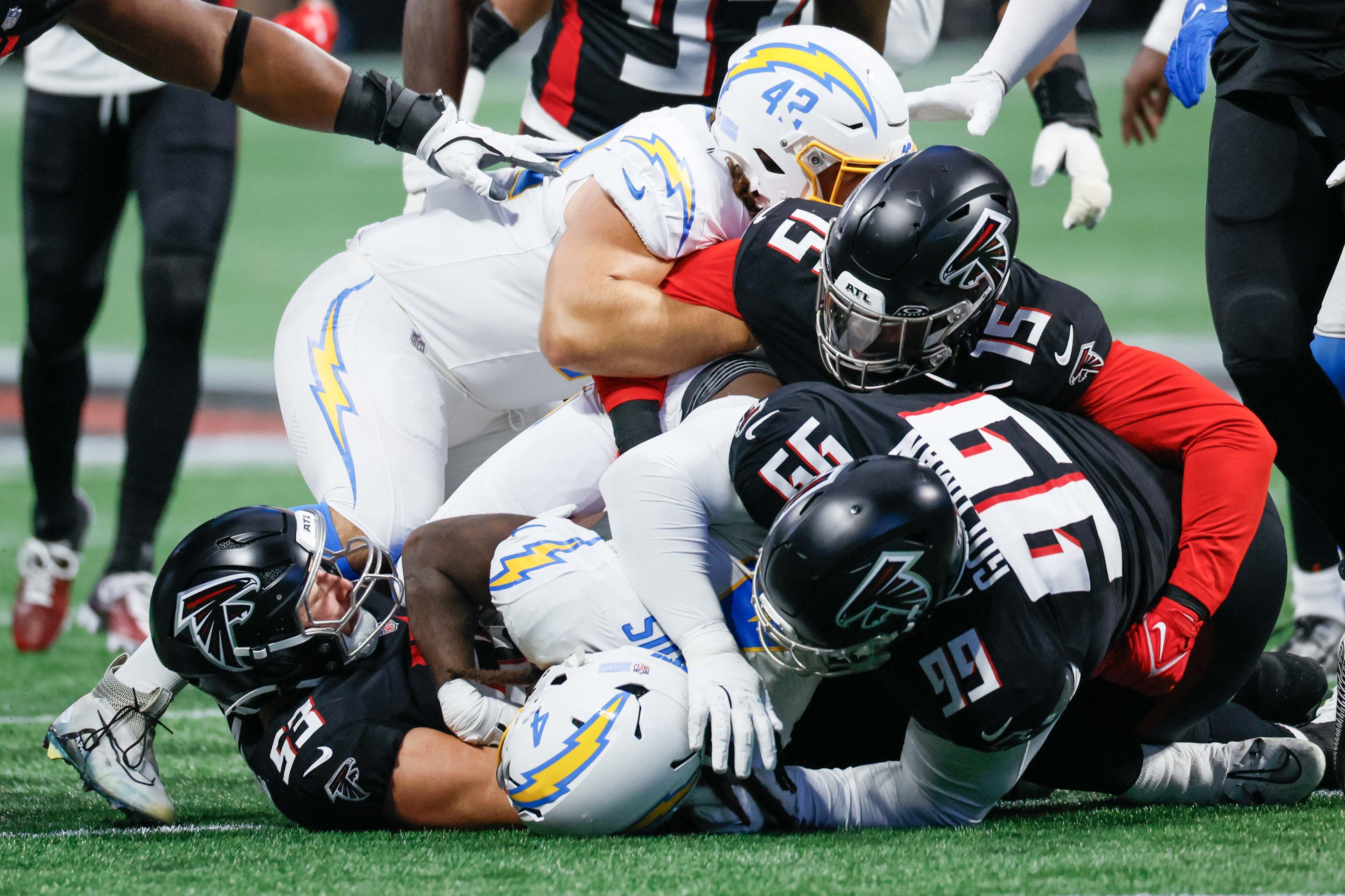 Los Angeles Chargers running back Gus Edwards gets tackled by Atlanta Falcons players during the first half of an NFL football game on Sunday, Dec. 1, 2024, at Mercedes-Benz Stadium in Atlanta.Â
(Miguel Martinez/ AJC)