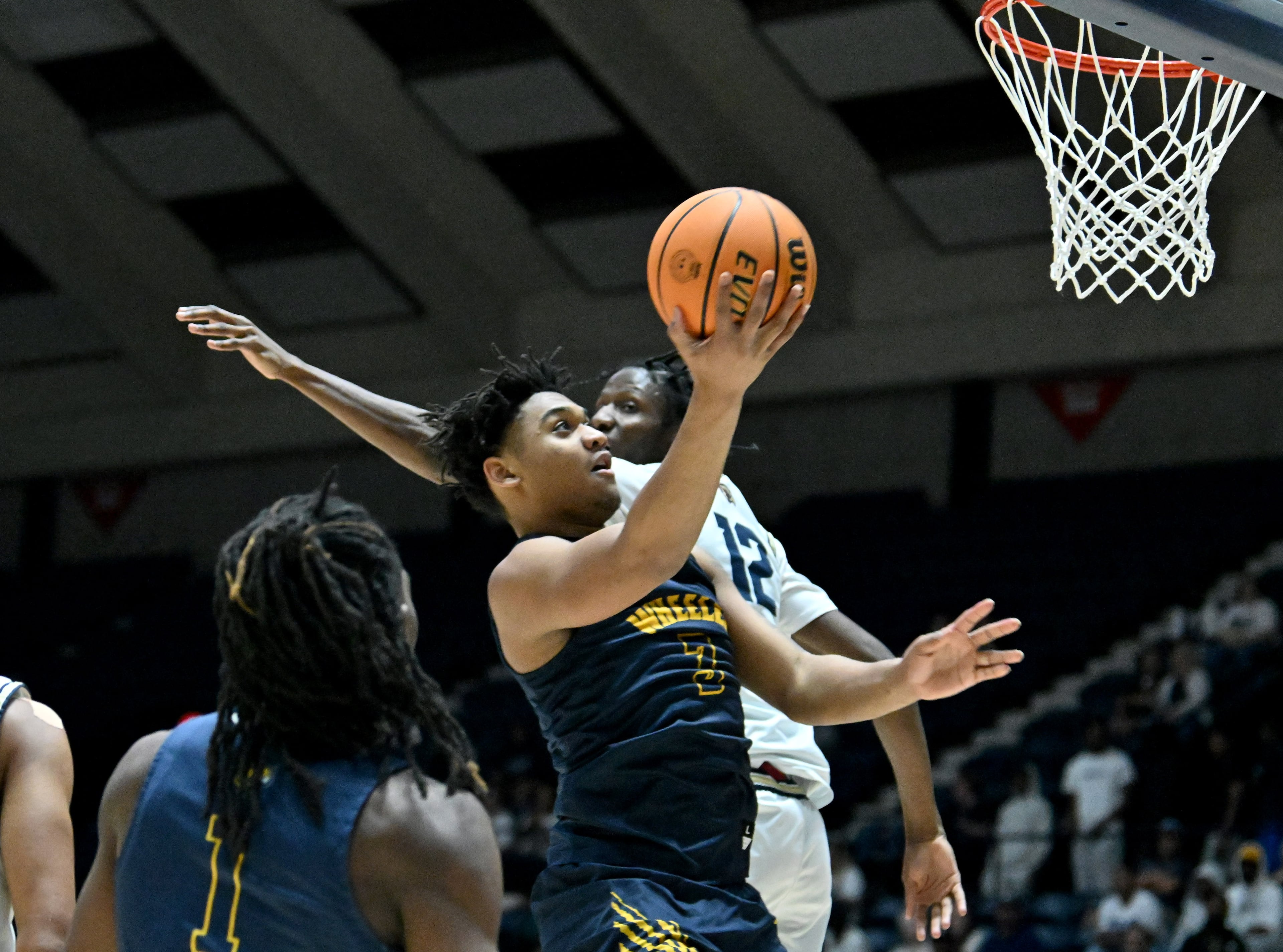 Wheeler Colben Landrew (3) goes to the basket for the shot past Pebblebrook Anthony Moon (12) during the first half in Class 6A Boys GHSA State Championship at the Macon Coliseum, Saturday, March 14, 2026, in Macon. Wheeler won 62-52 over Pebblebrook. (Hyosub Shin/AJC)