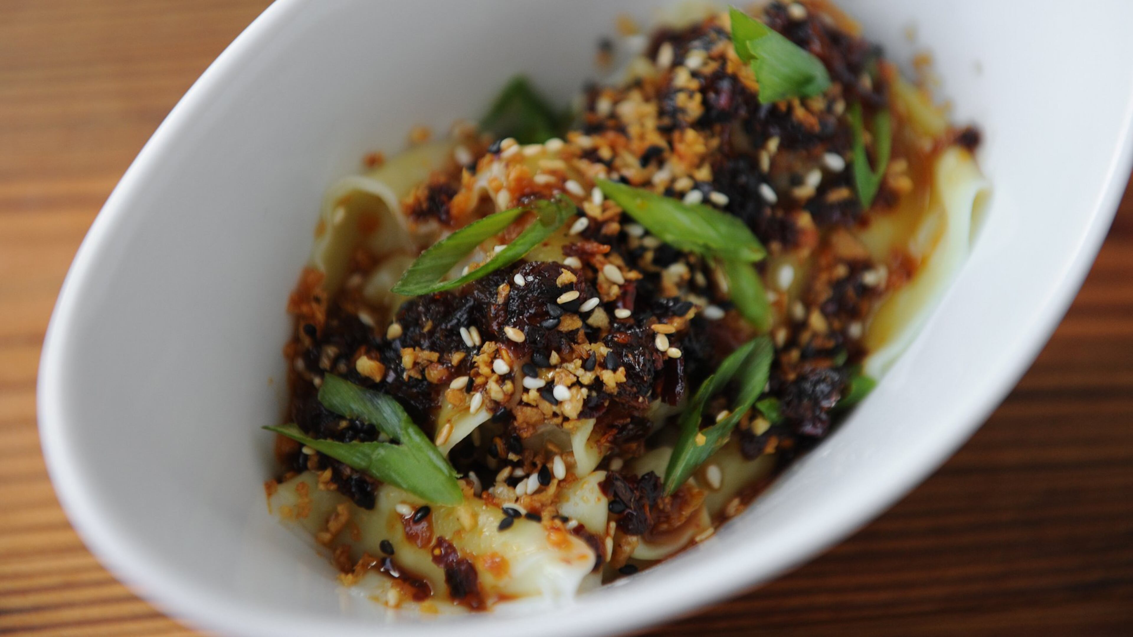 At Ba Bellies, the sweet chili wonton comes with heritage pork and shrimp, chili, palm sugar, fried garlic and shallot, and scallions. (BECKY STEIN PHOTOGRAPHY)