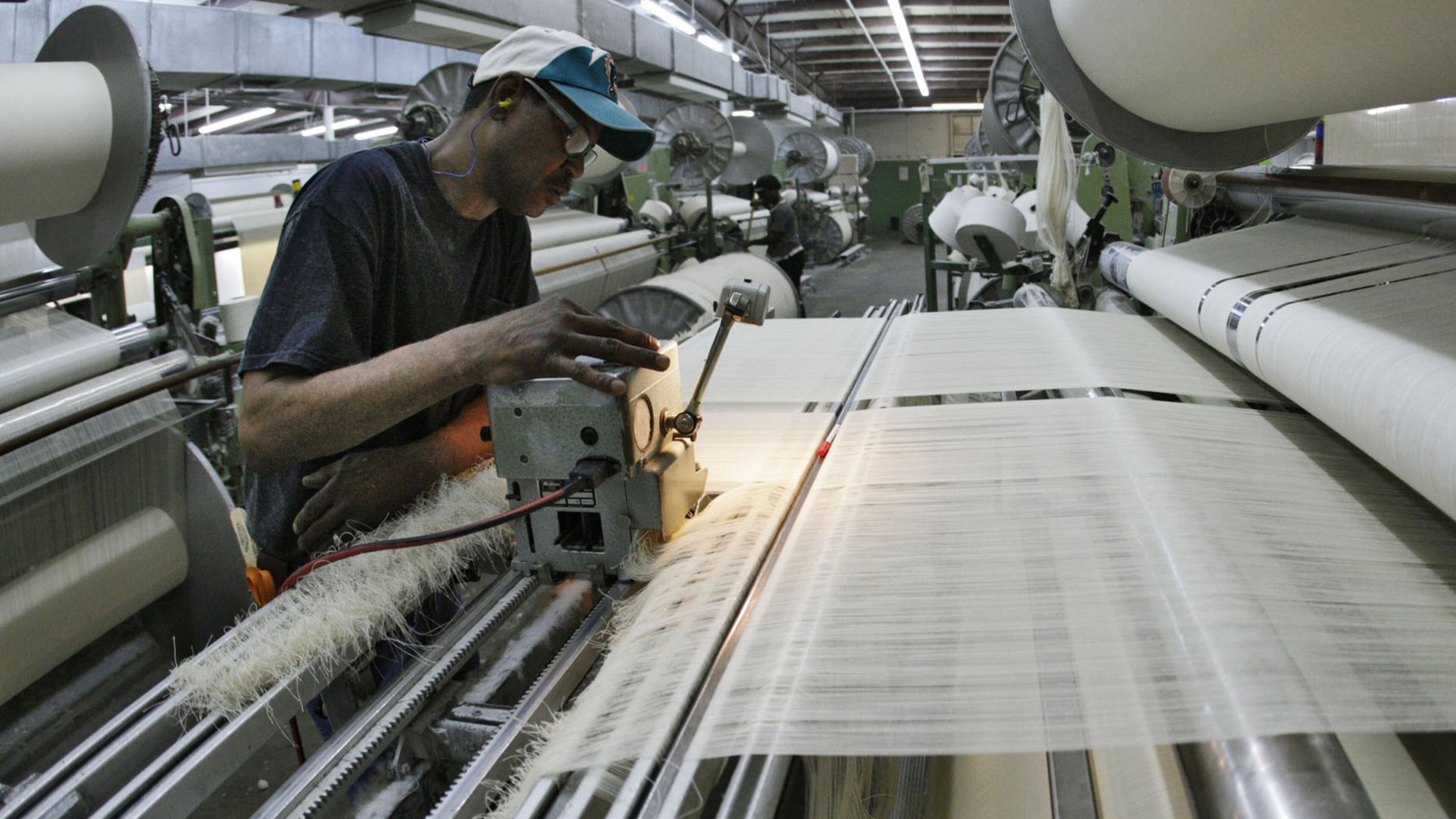 Tony Berry tends to a loom in the weaving area of 1888 Mills in Griffin.