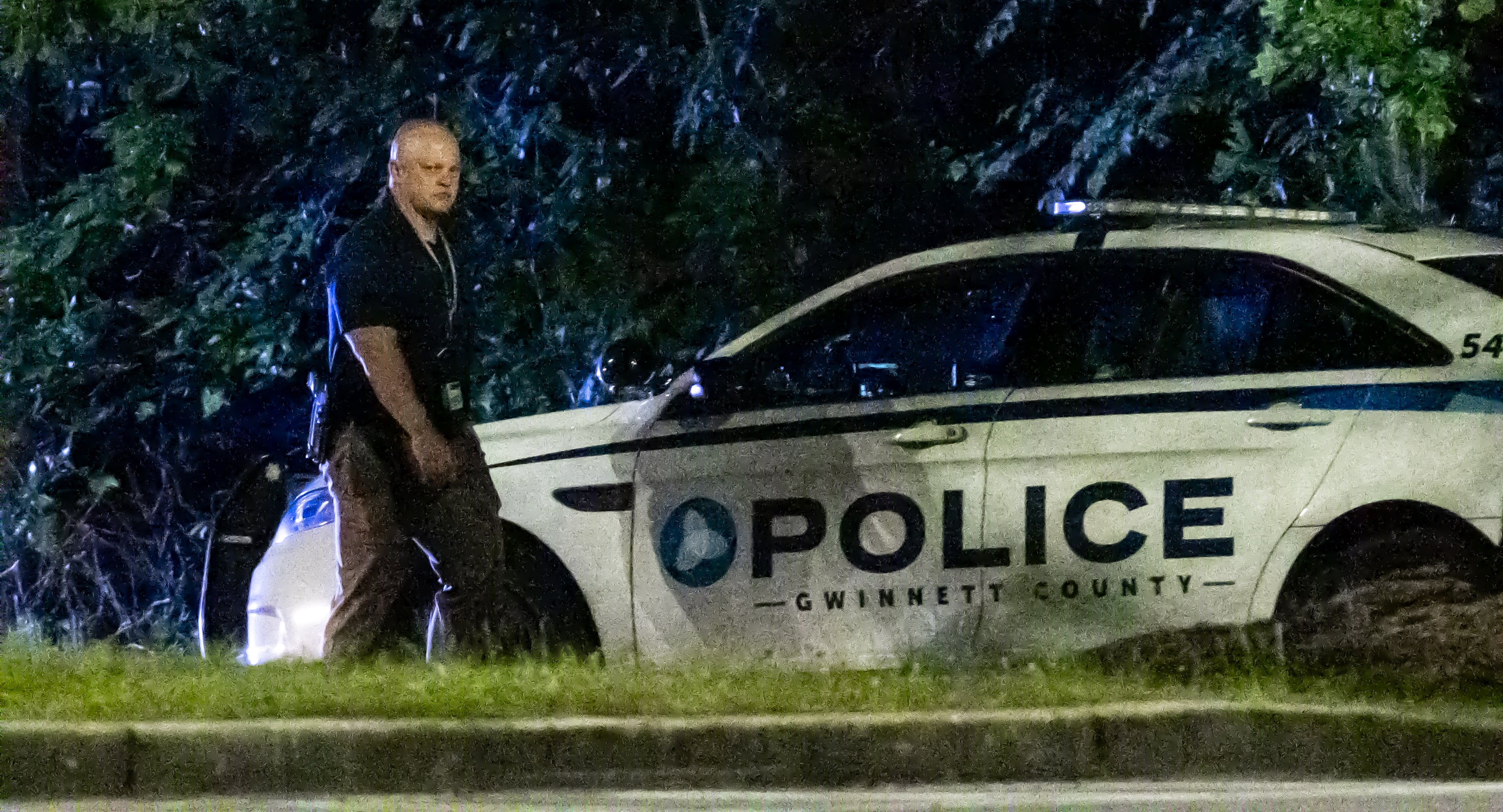 Gwinnett police examine the scene of a shooting, where a man and three children shot to death inside a car at Lucky Shoals Park outside of Tucker on Wednesday, May 8, 2024. The man was in the driver’s seat. He, a boy and two girls all appeared to have been shot. Their names and ages were not released, but authorities said the children appeared to have been in elementary and middle school. (John Spink/AJC)